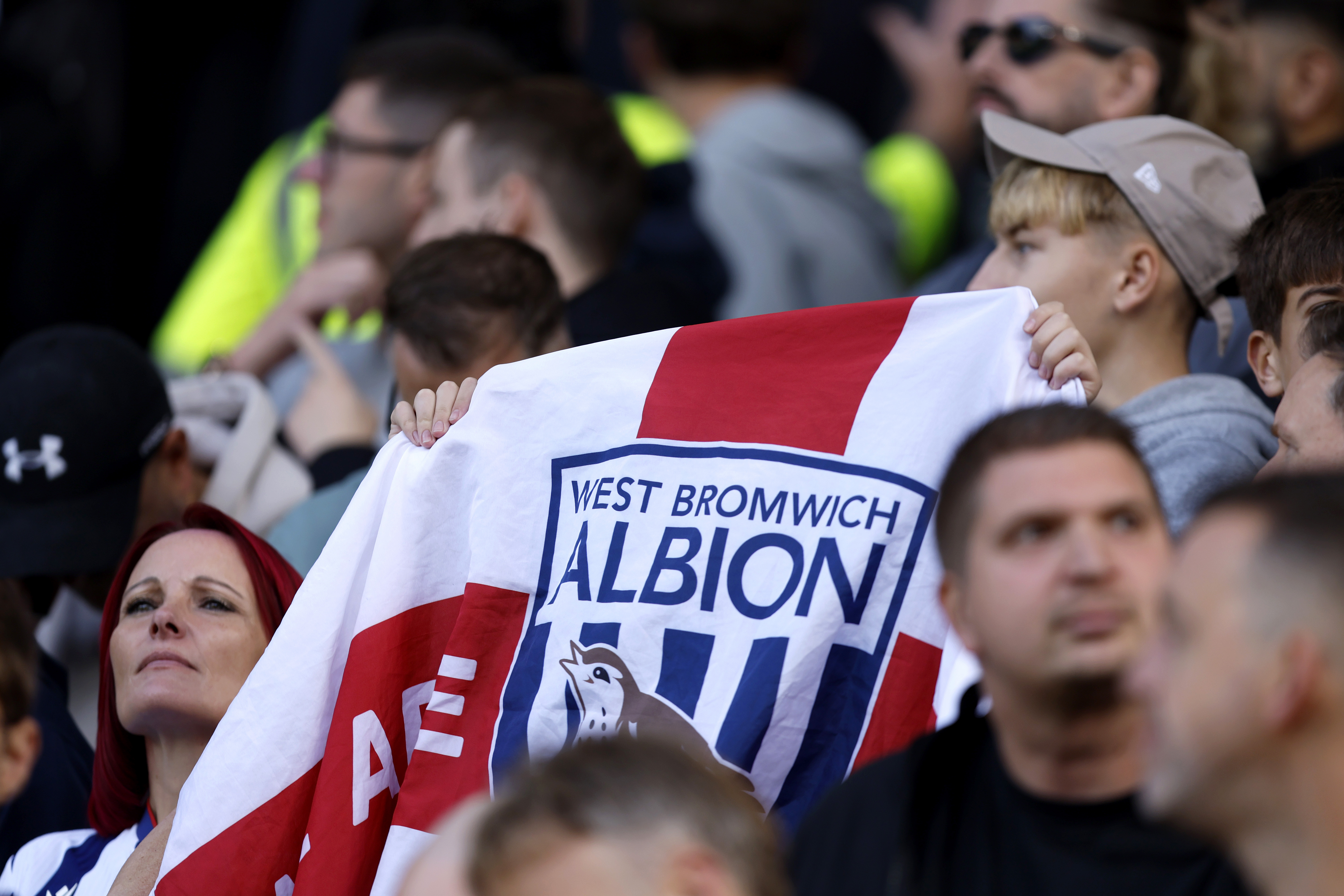 A WBA fan holding up a WBA England flag 