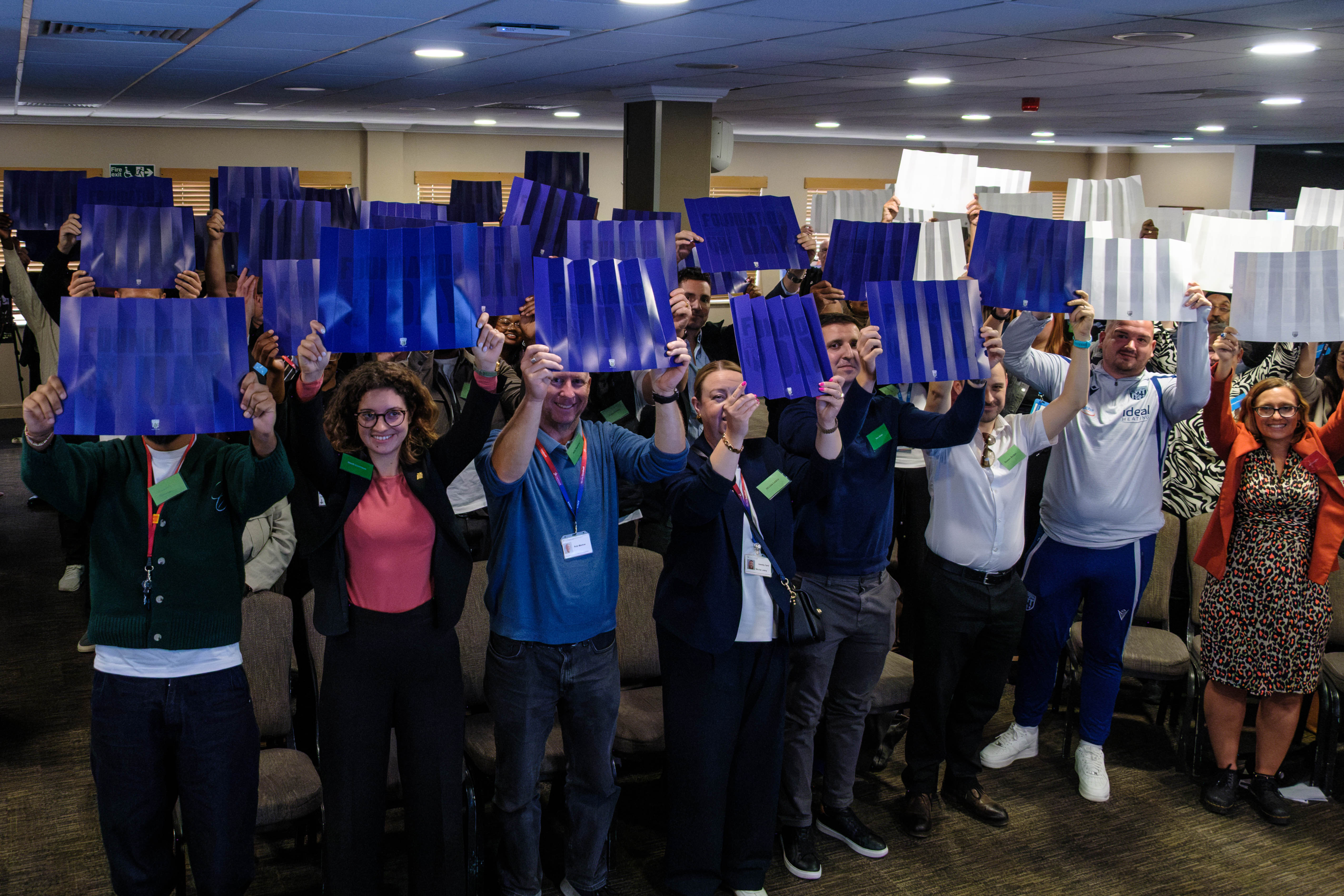 Guests holding up blue and white clappers