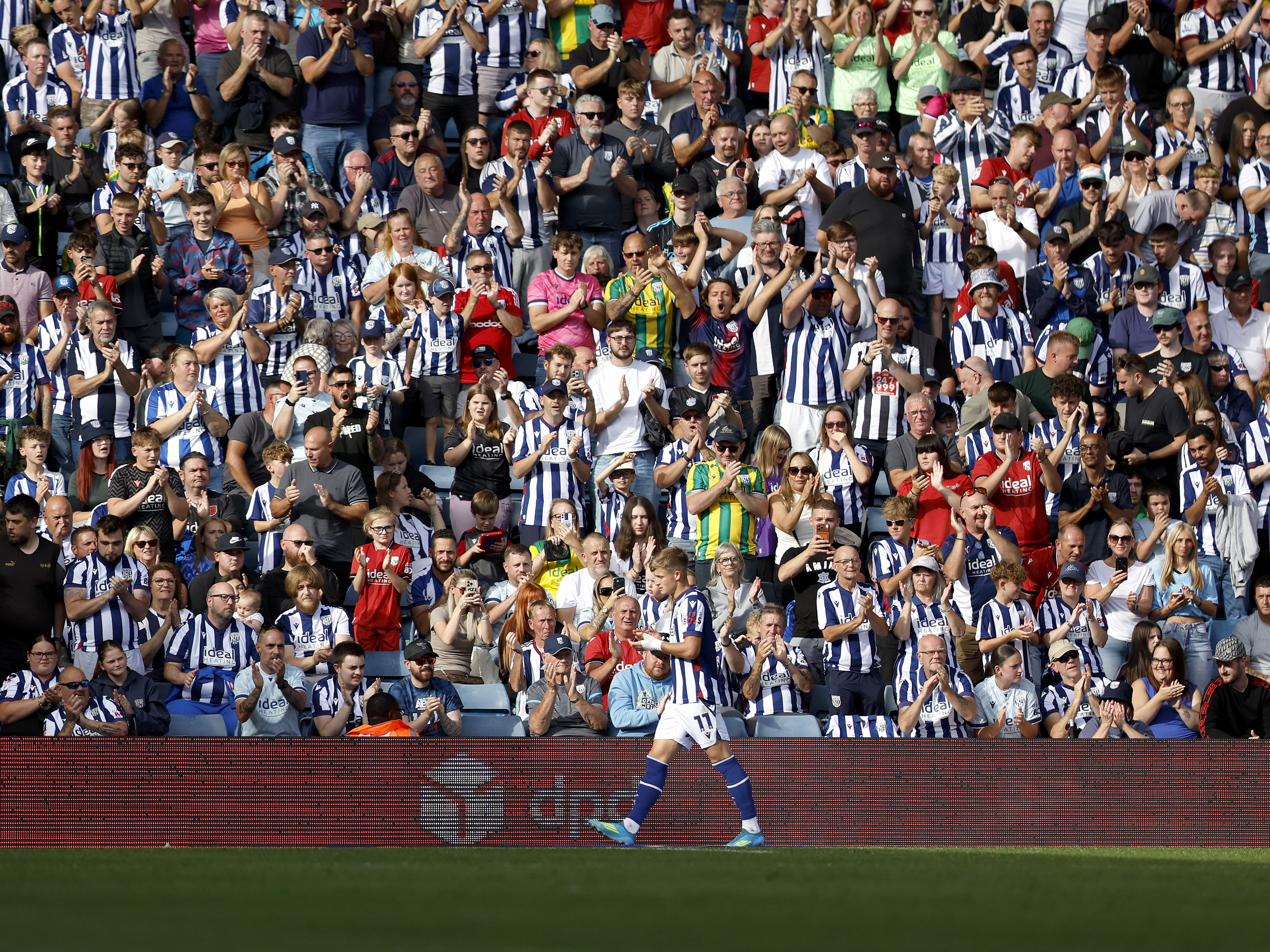 An image of Albion fans applauding JJ Morgan