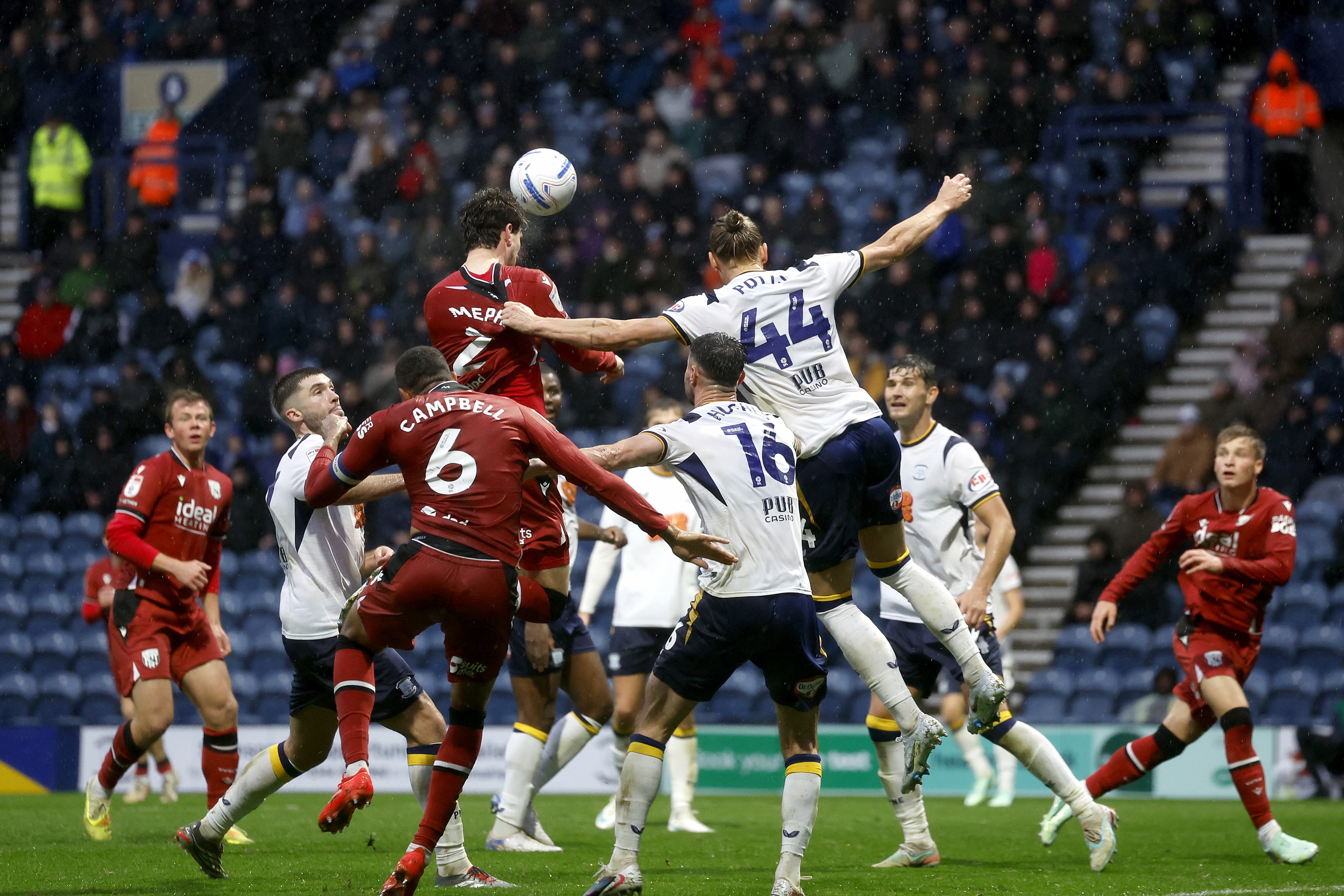 Chris Mepham head the ball against Preston