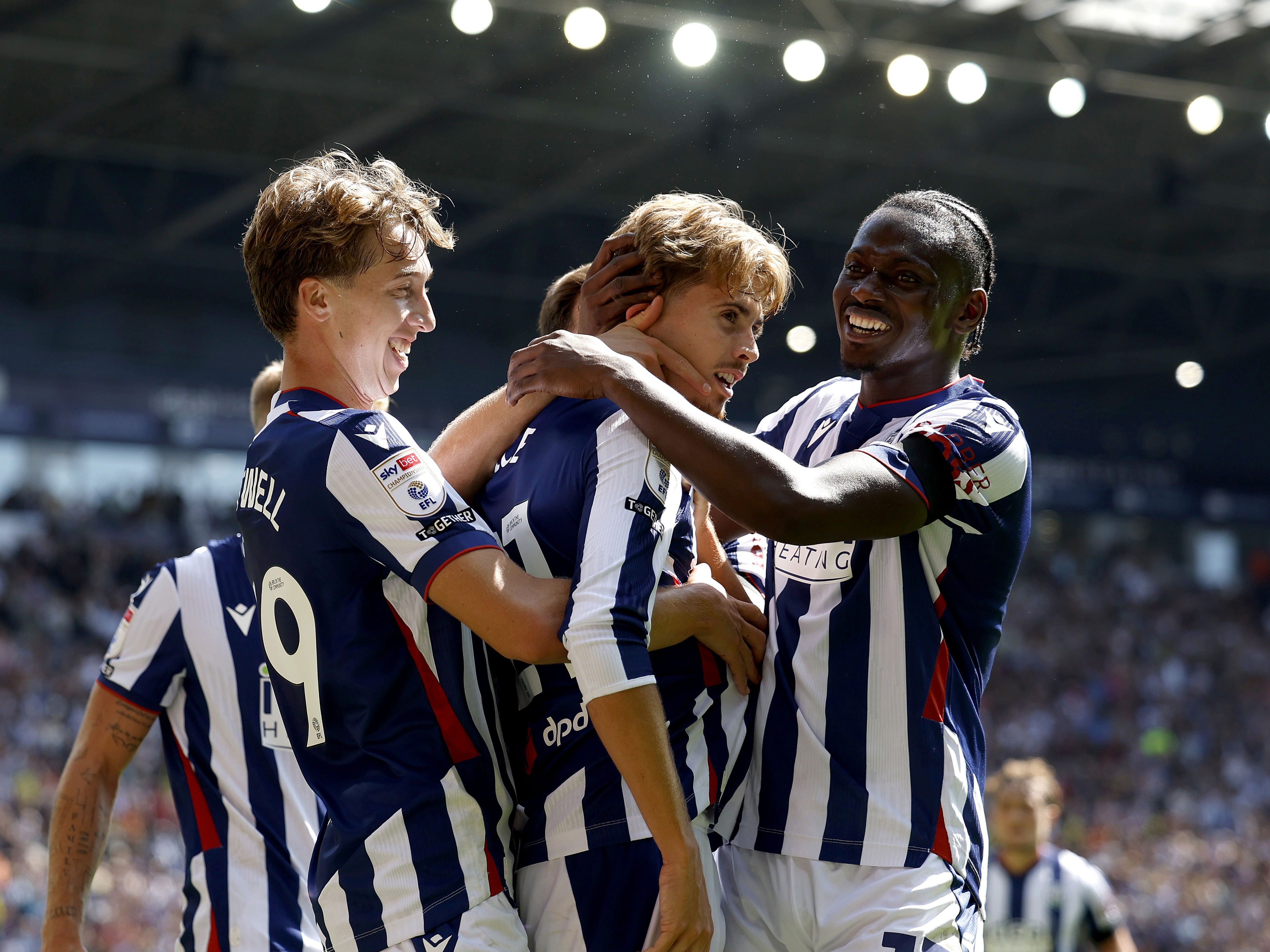 Isaac Price celebrates scoring a goal in the home kit at The Hawthorns with Harry Whitwell and Ousmane Diakité