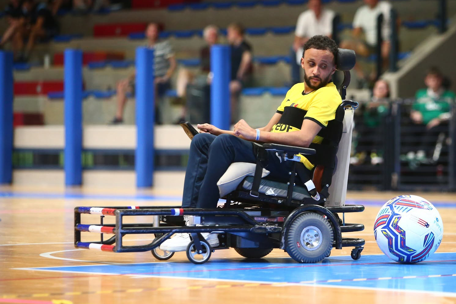 Bryan Weiss in his chair with the ball next to his back bummer.