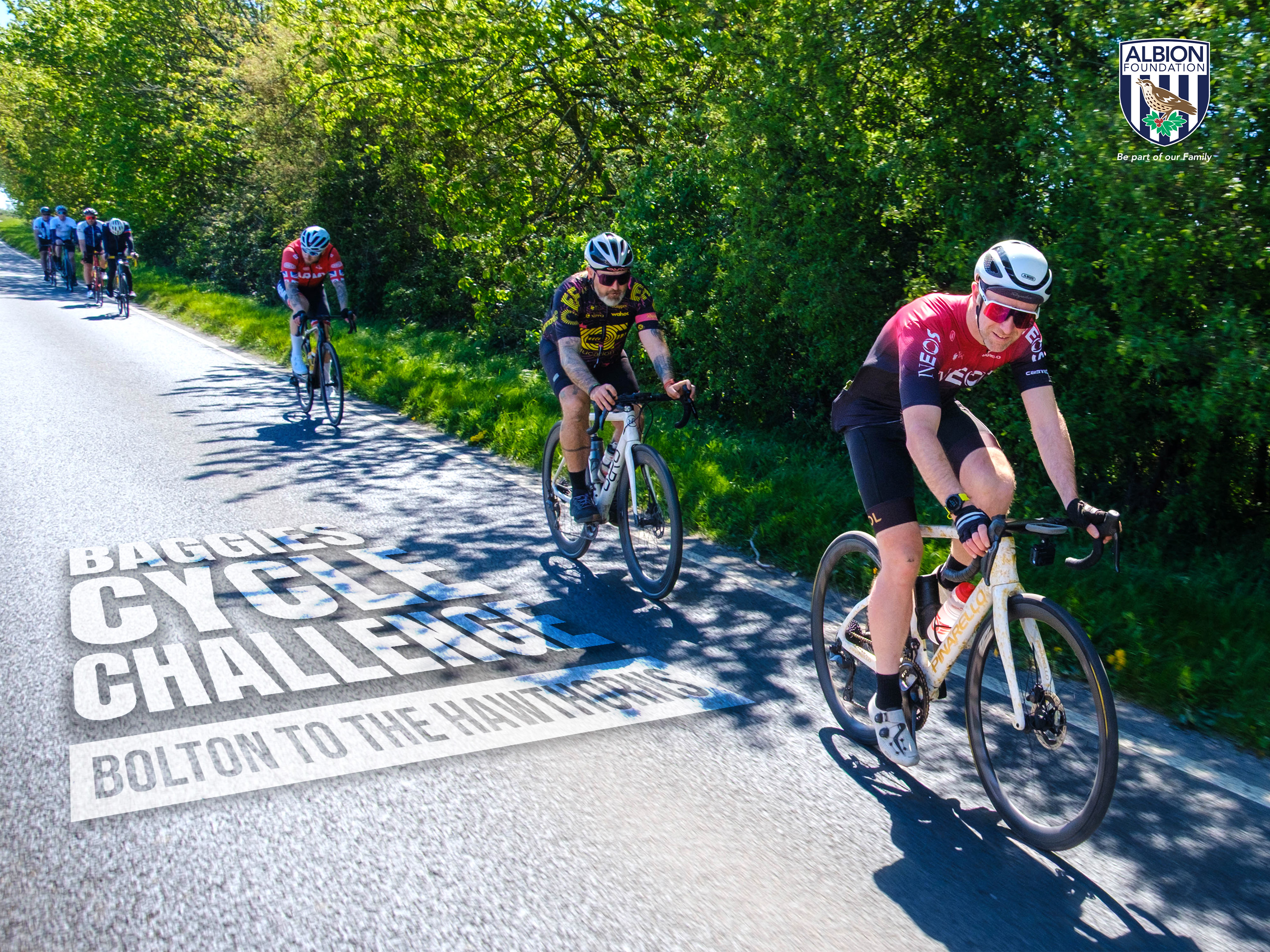 A group of cyclists ride along a tree-lined country road under sunny skies, with text reading “Baggies Cycle Challenge: Bolton to The Hawthorns.” The Albion Foundation logo appears in the top-right corner.