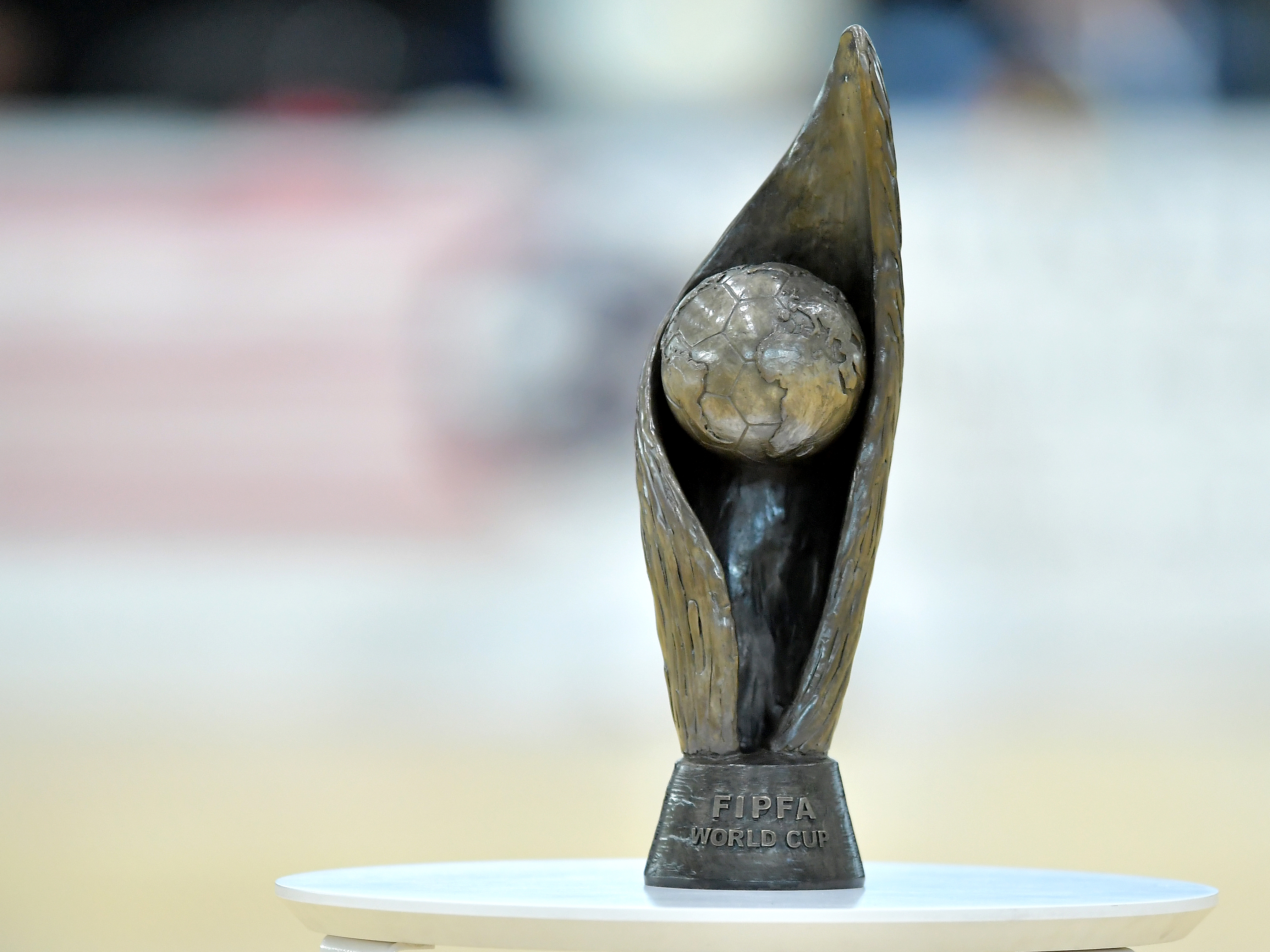 World Cup Trophy on table with a blurred background.
