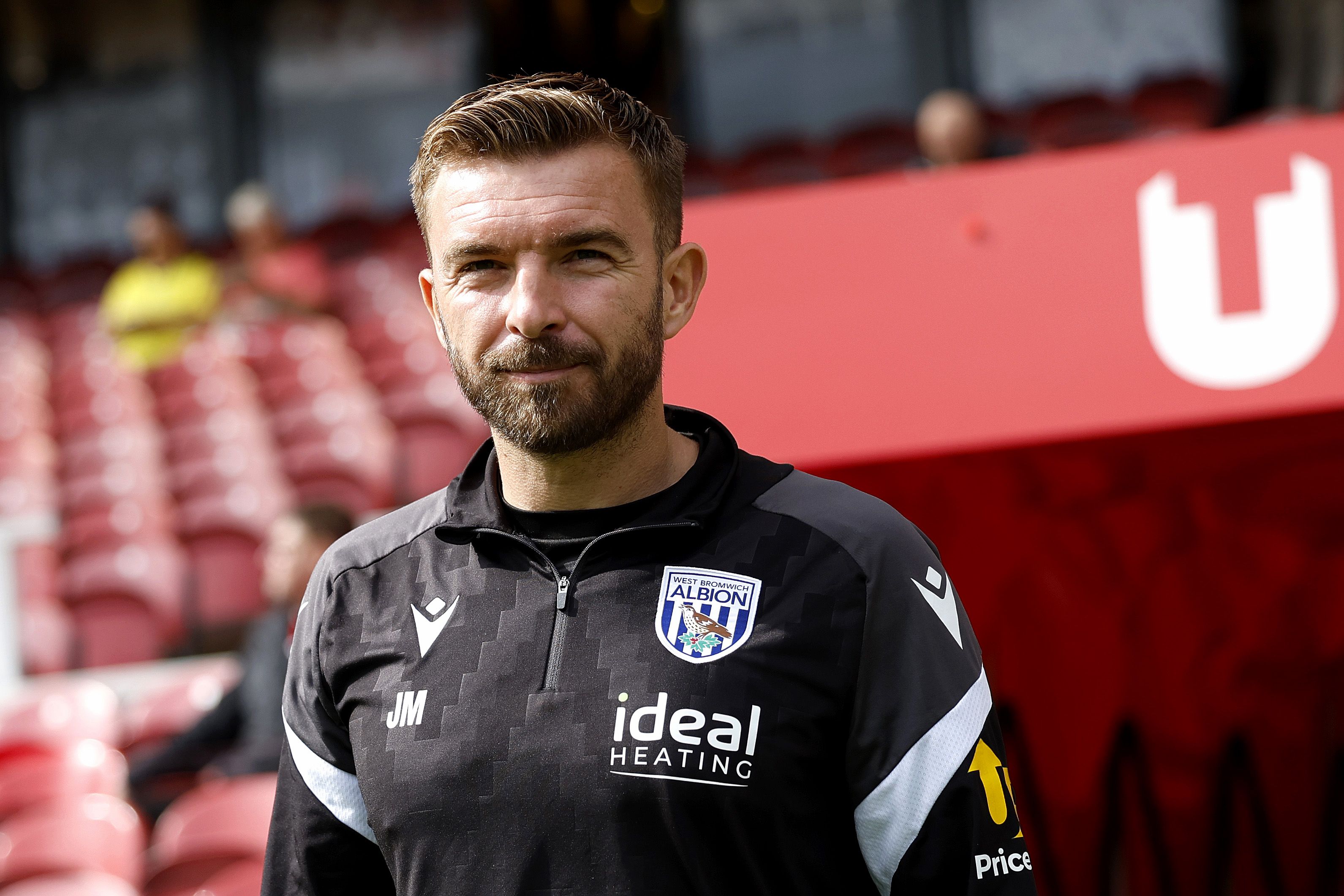 James Morrison smiling while in a black WBA tracksuit 