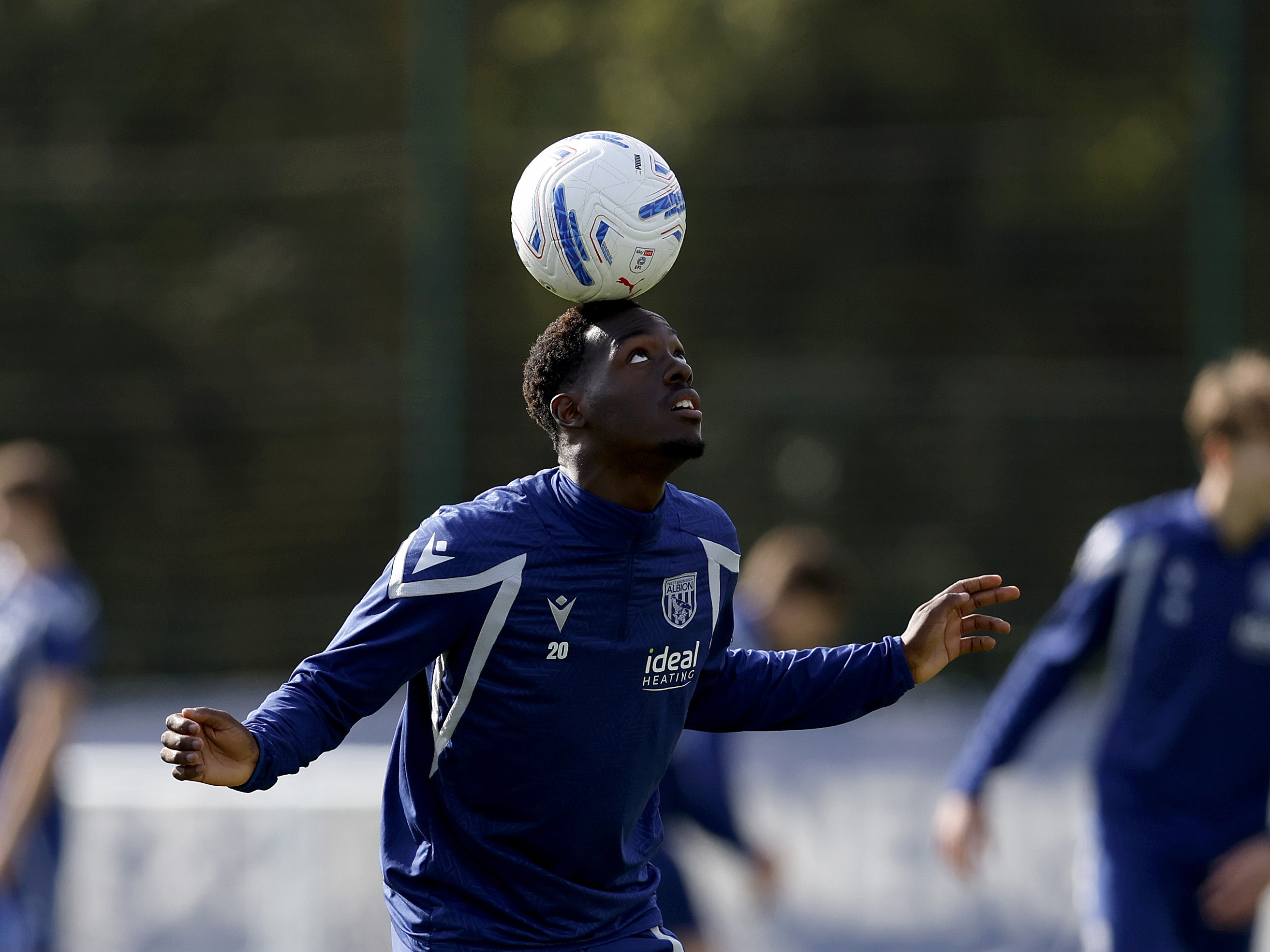 Rabby Nzingoula balancing a ball on his head during training 
