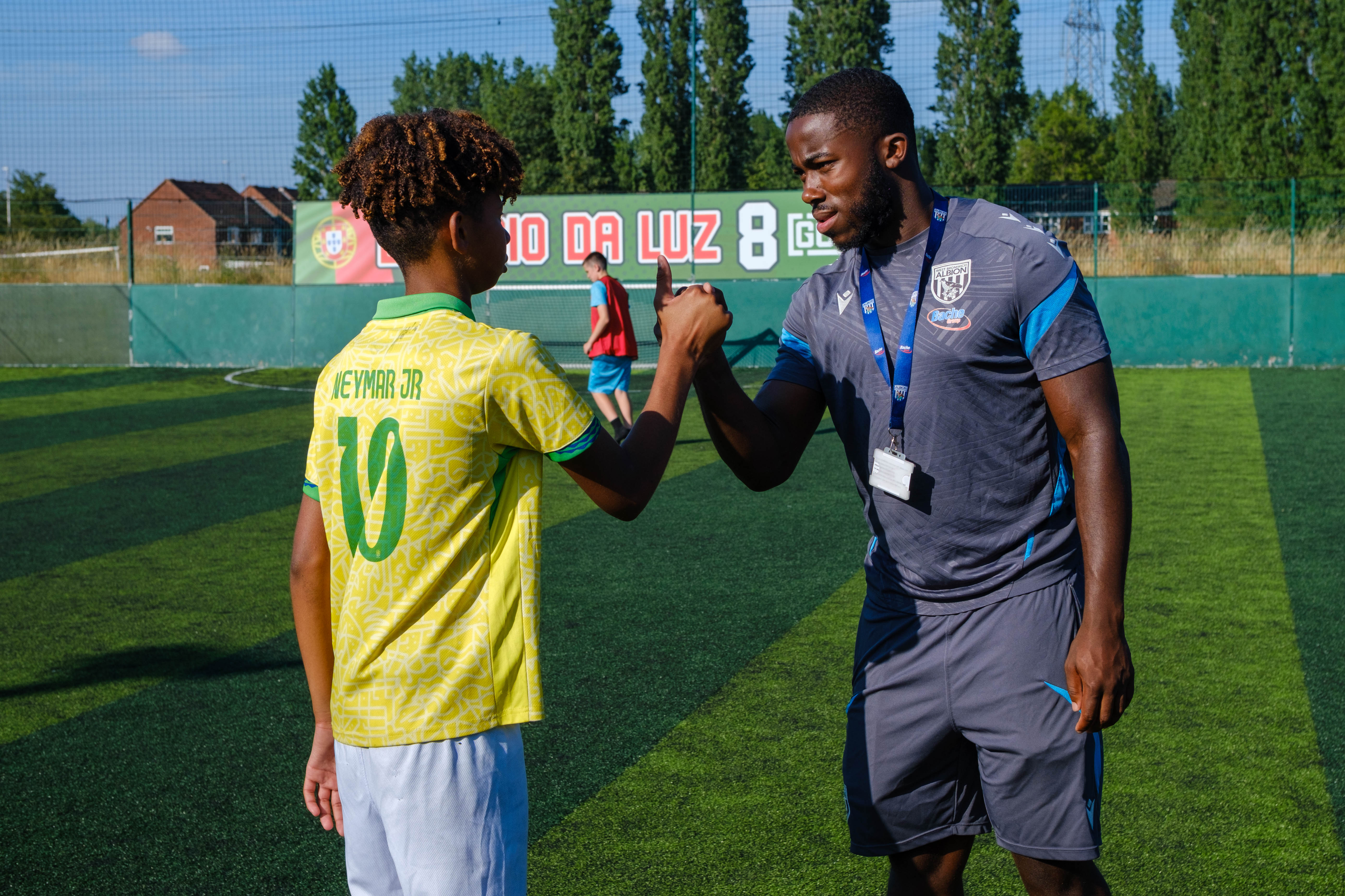 Kadeem Jordan greeting a young footballer