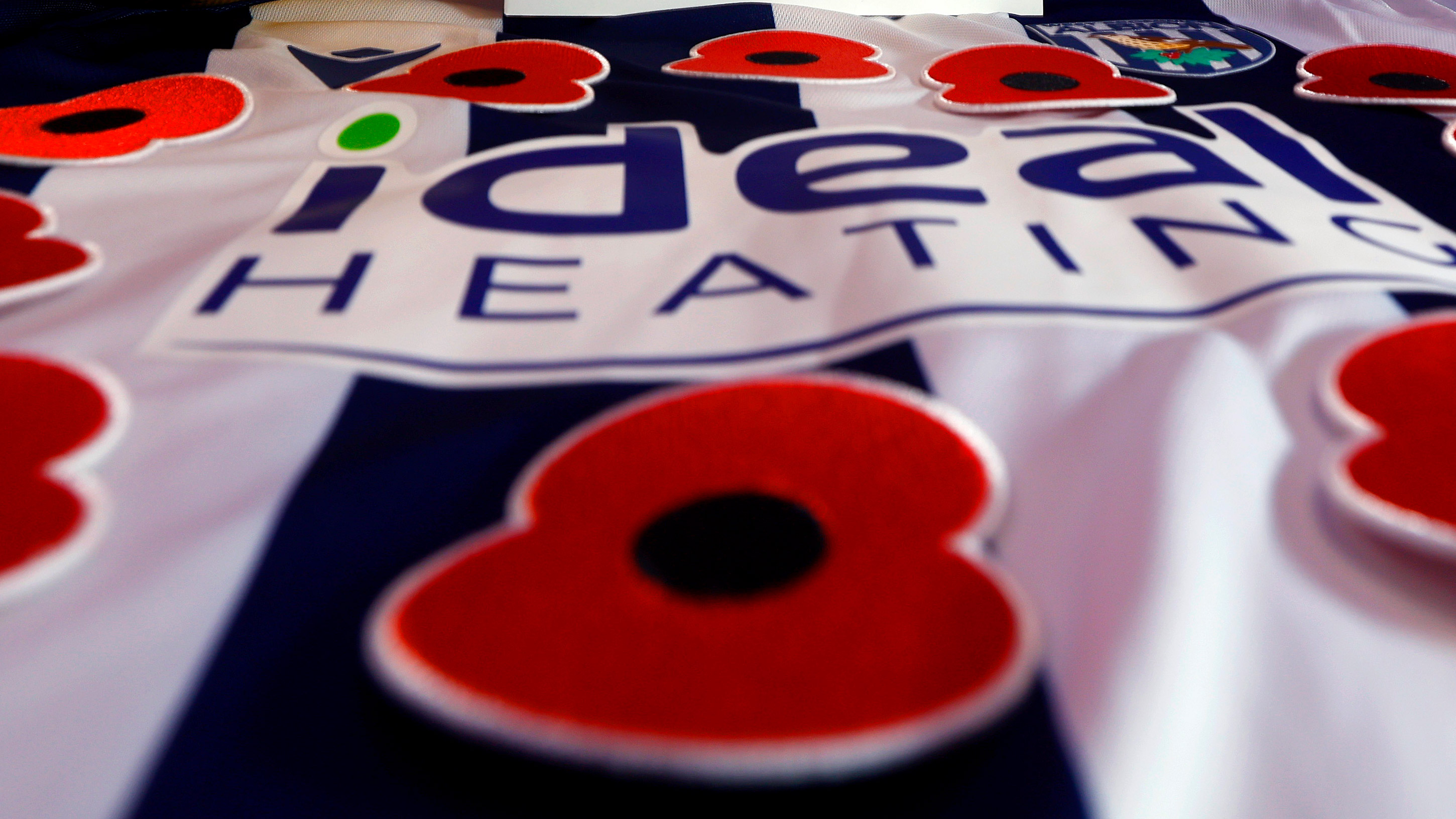 An Albion home shirt with poppies on it
