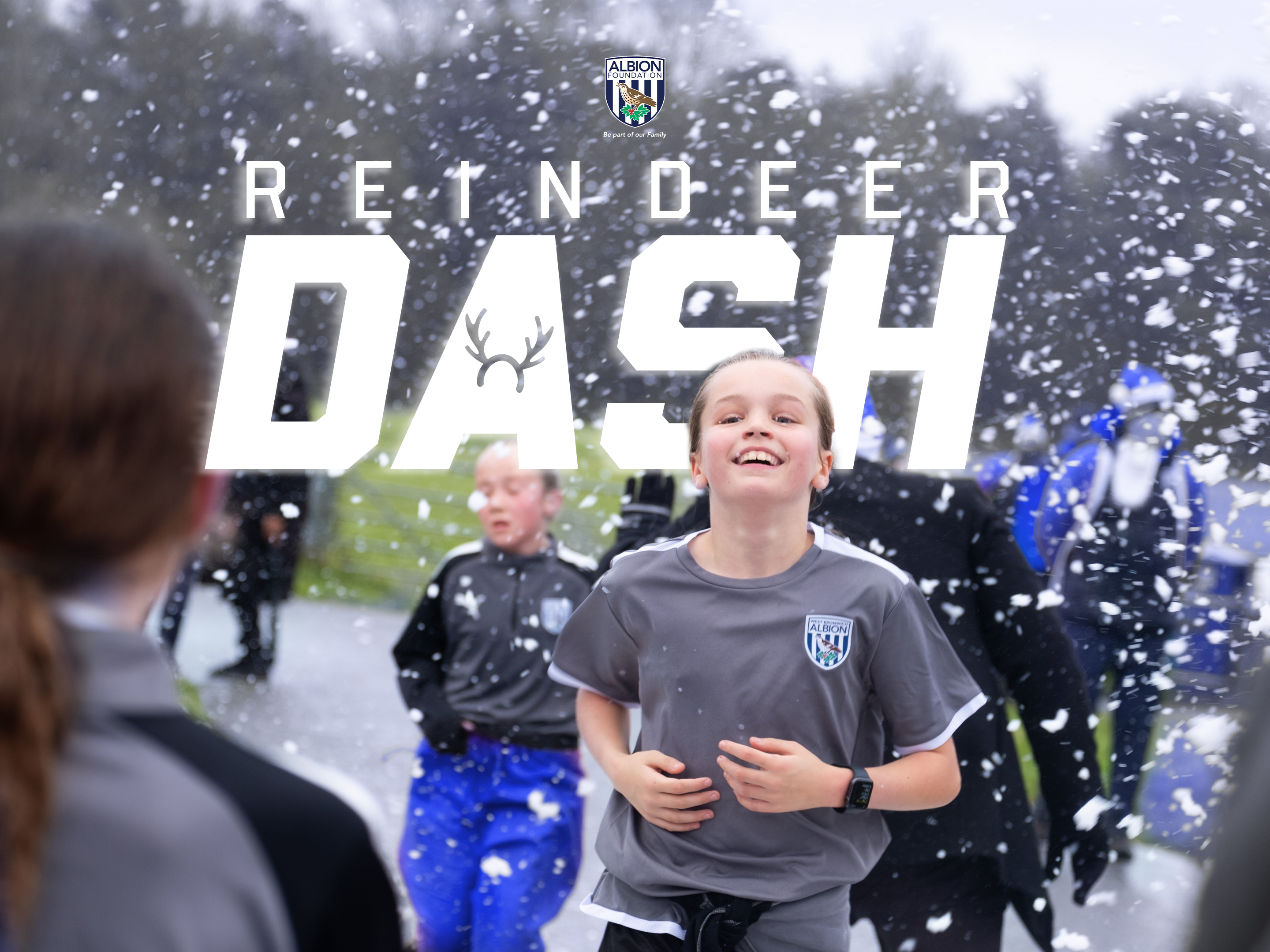 Participant running with foam floating in the background and Reindeer Dash text behind them.