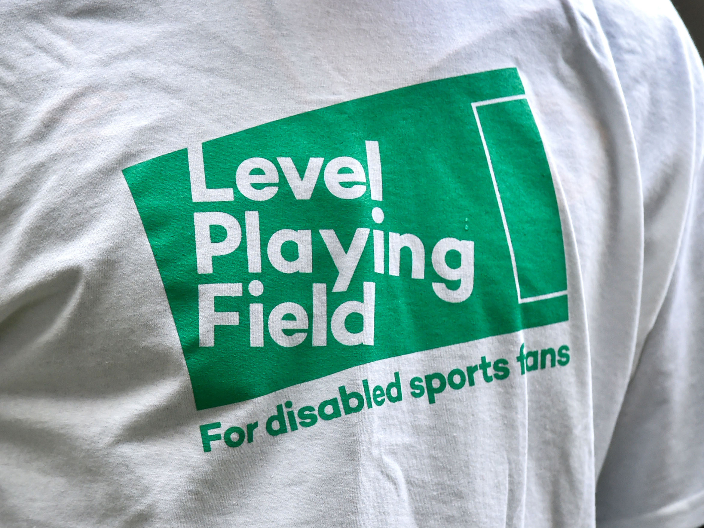 A Level Playing Field logo on a white warm-up t-shirt 
