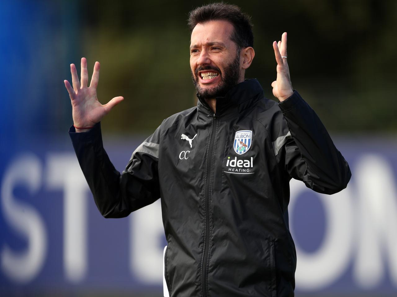 Carlos Corberán watching over training 