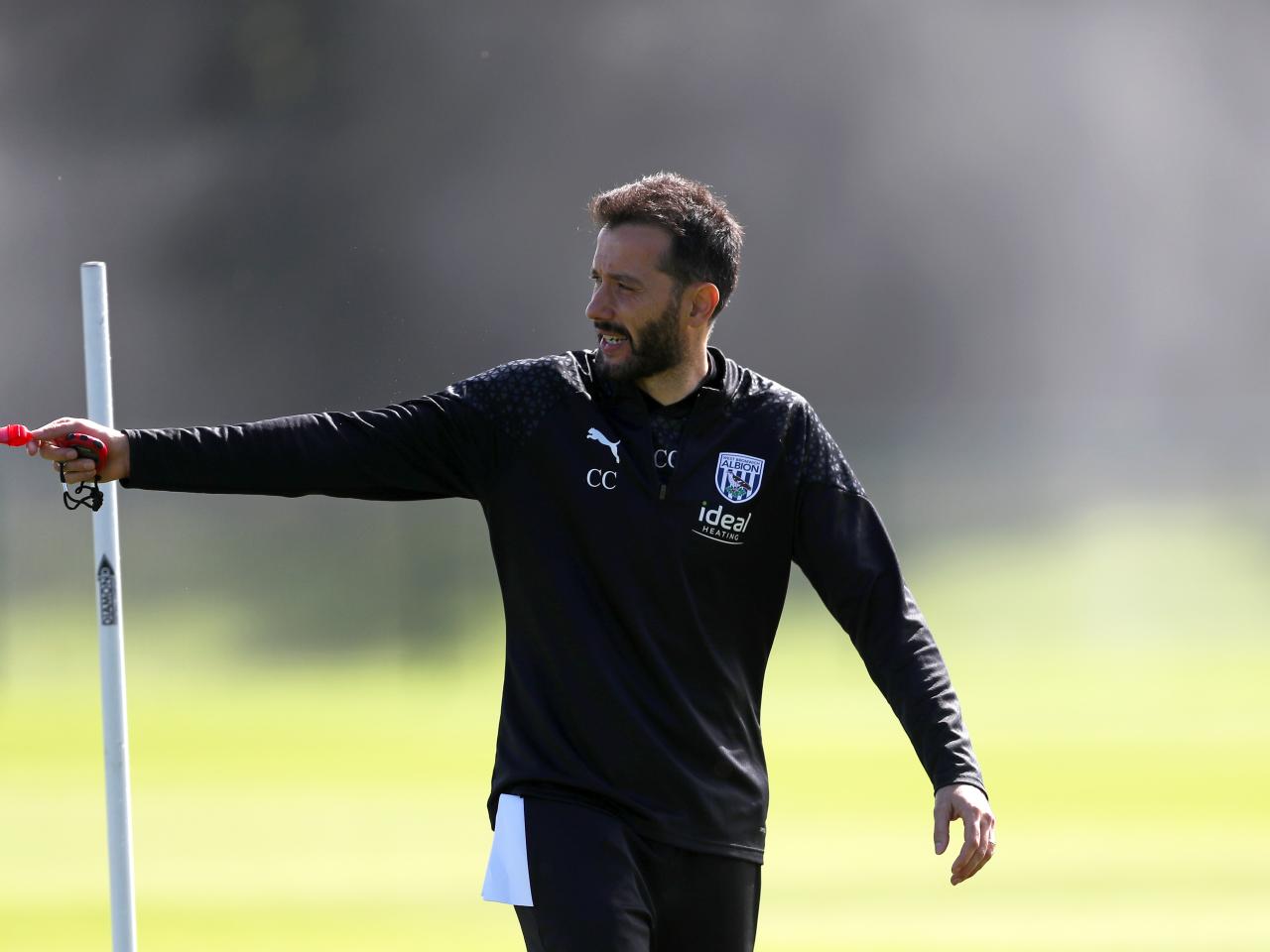 Carlos Corberán watching over training 