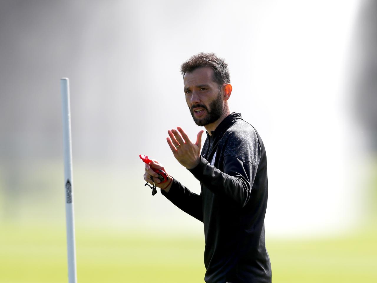 Carlos Corberán watching over training 
