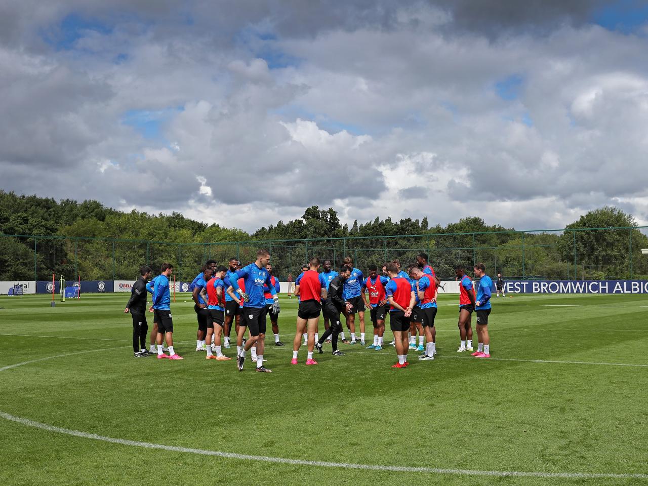 The players in a huddle on the training pitch