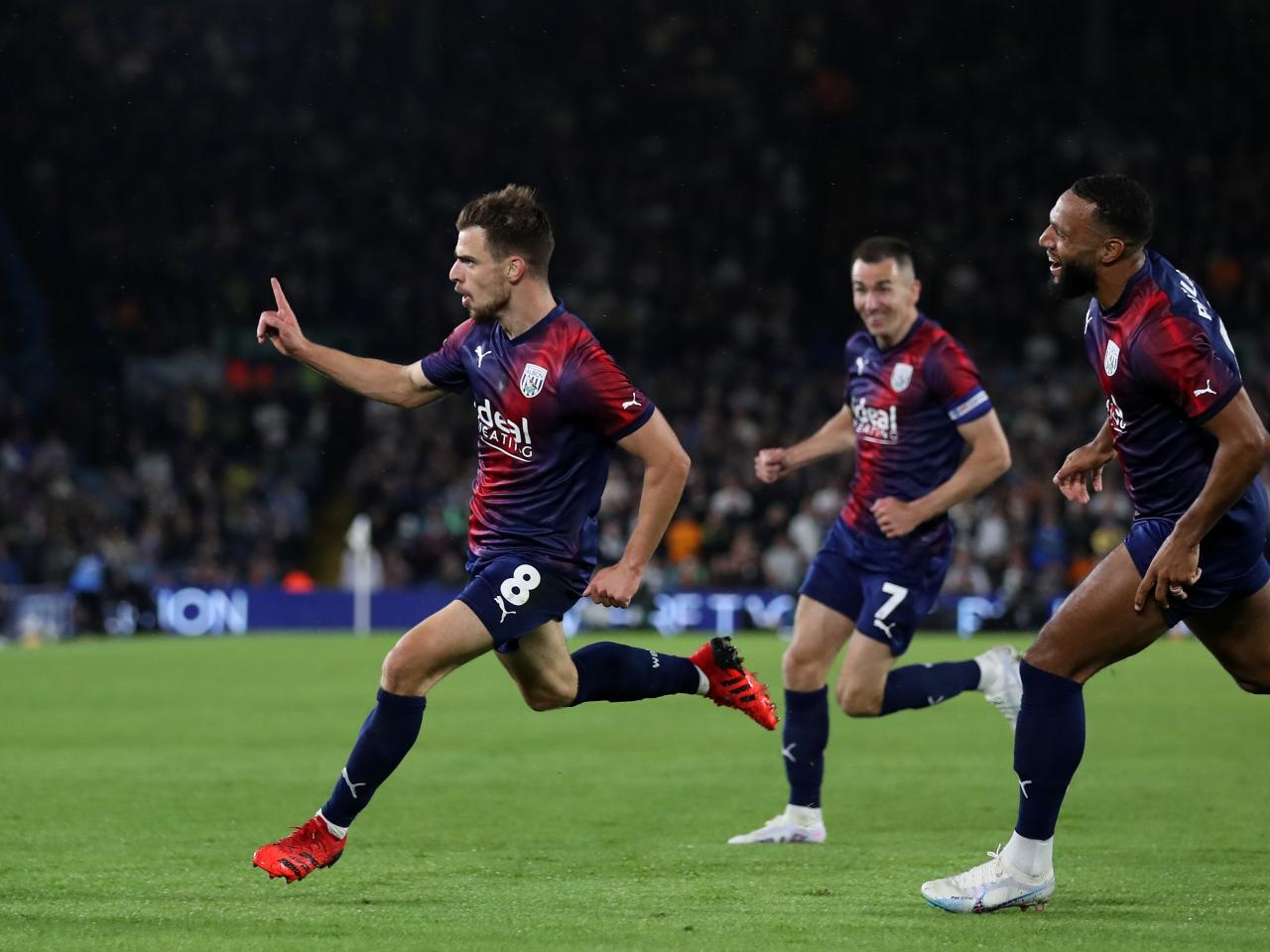 Jayson Molumby celebrates Albion's goal at Leeds with team-mates