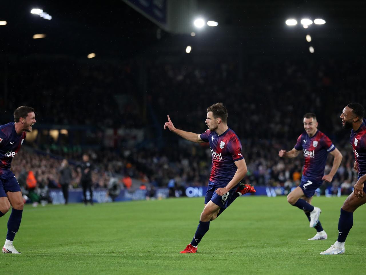 Jayson Molumby celebrates Albion's goal at Leeds with team-mates