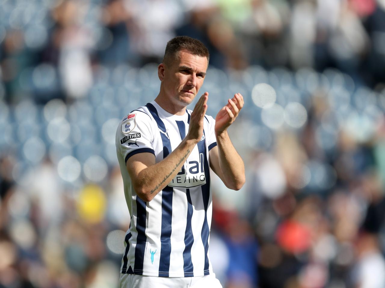 Jed Wallace applauds the fans at full time