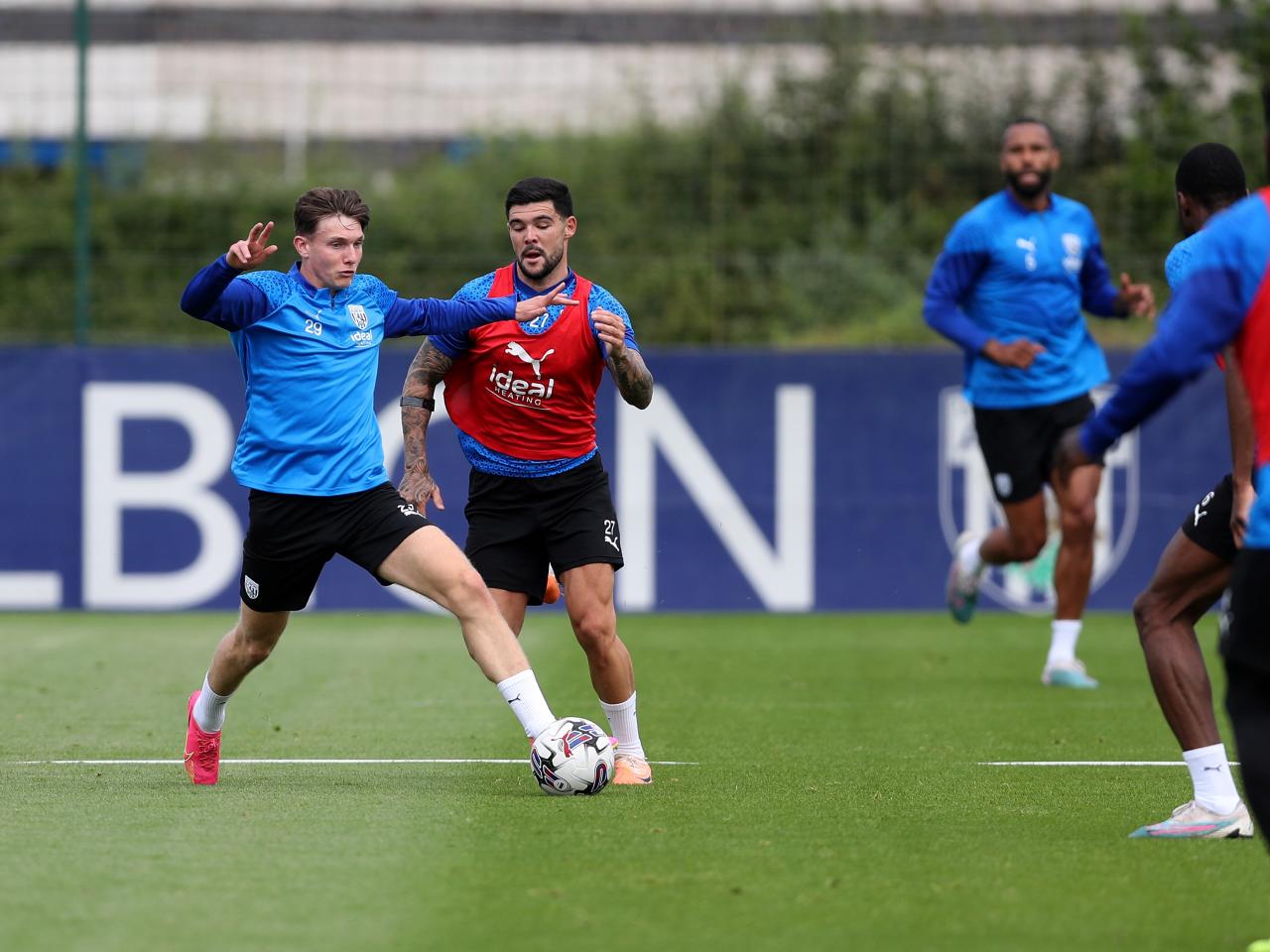 Taylor Gardner-Hickman and Alex Mowatt battle for the ball in training 