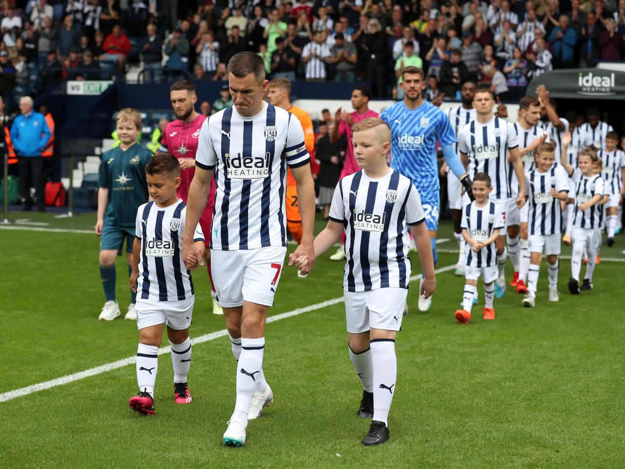 Jed Wallace leads Albion out onto the pitch before kick-off with two mascots