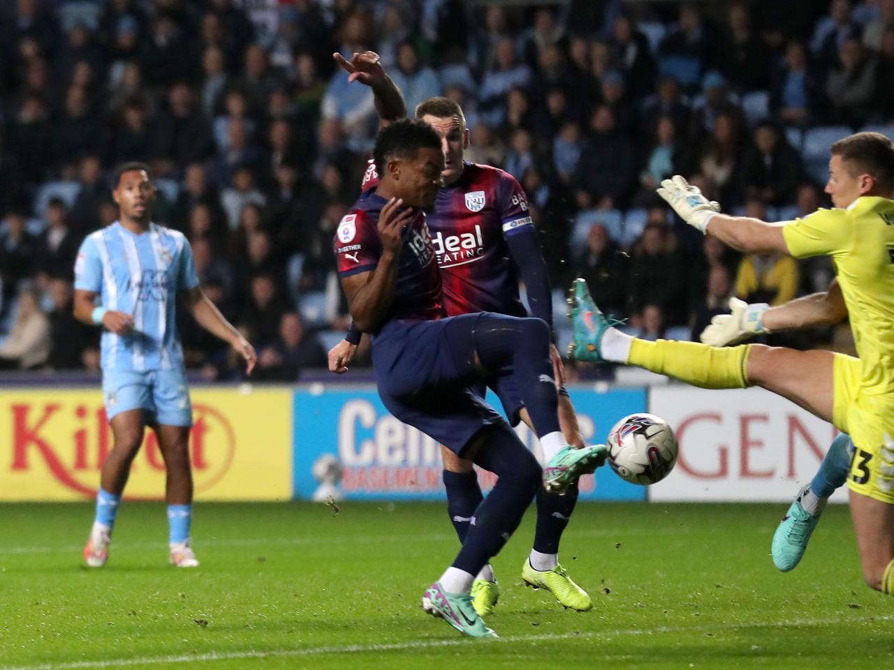 Grady Diangana challenges for the ball against Ben Wilson Coventry's goalkeeper