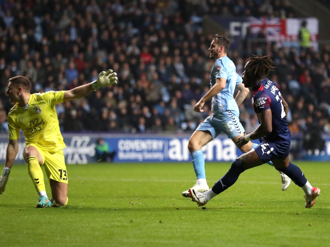 Brandon Thomas-Asante watches the ball fly past Ben Wilson in the Coventry goal