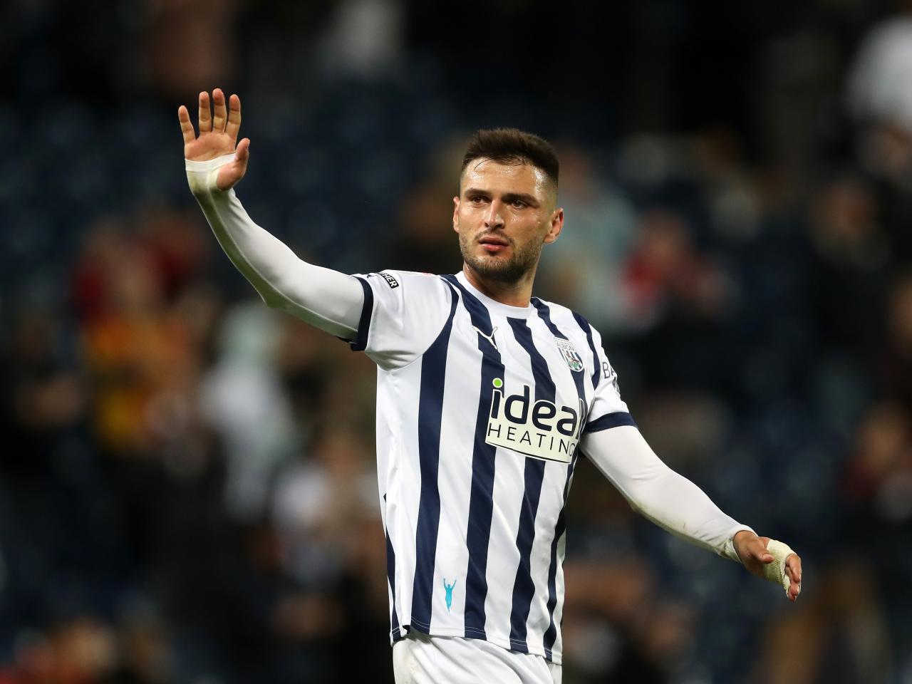 Okay Yokuslu waves to fans after the final whistle