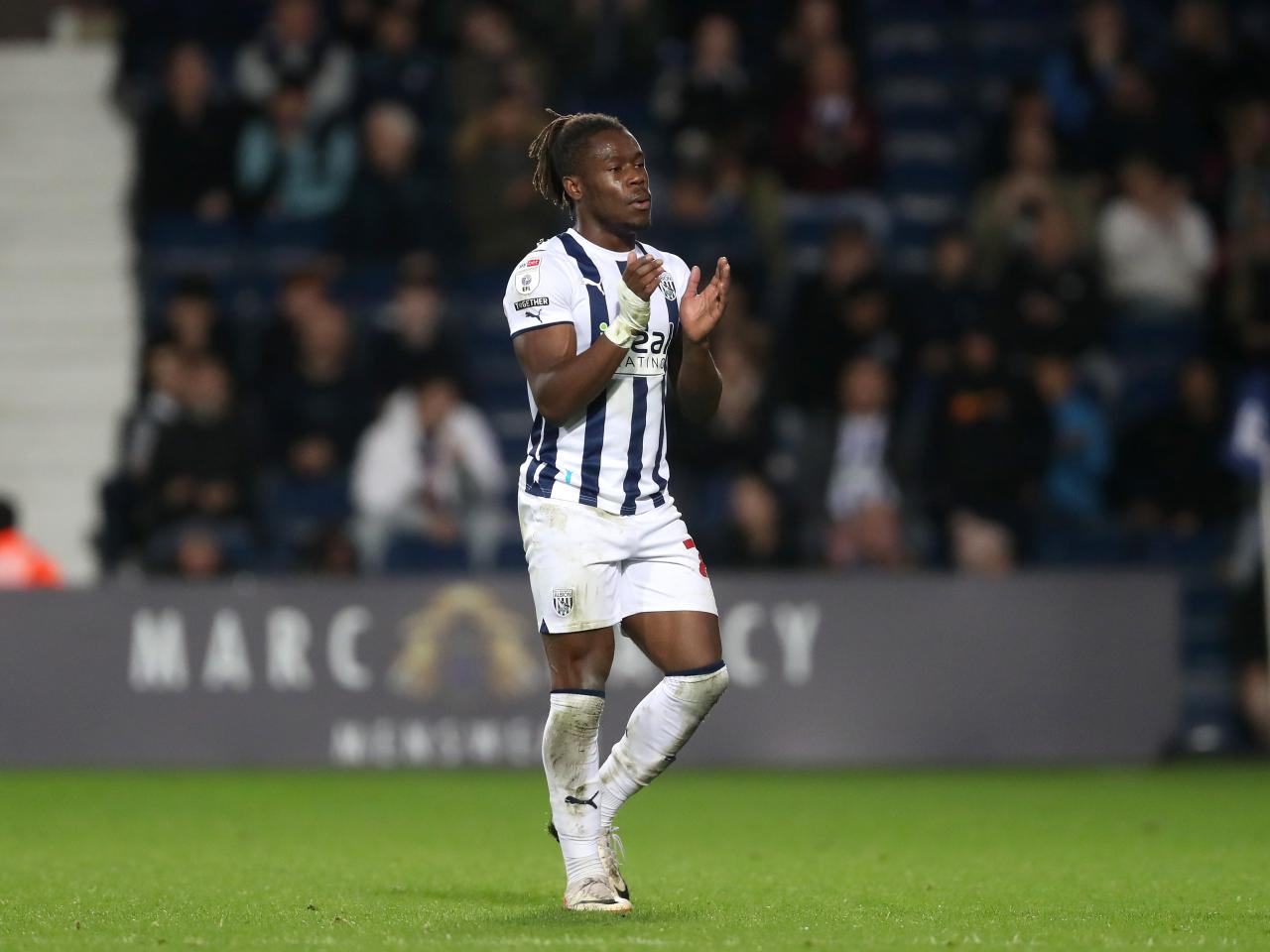 Brandon Thomas-Asante applauds supporters as he leaves the pitch