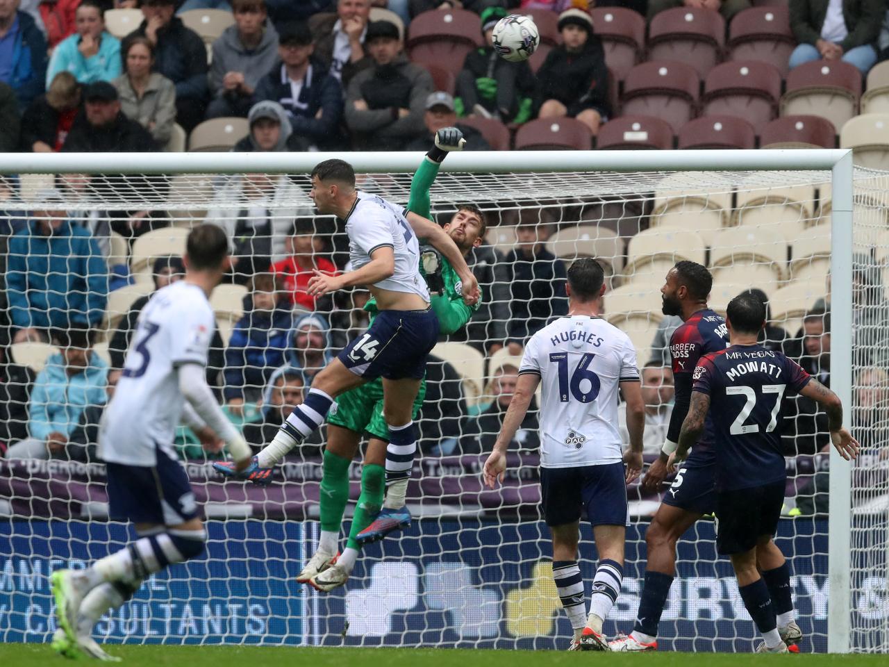 Alex Palmer punches the ball clear against Preston