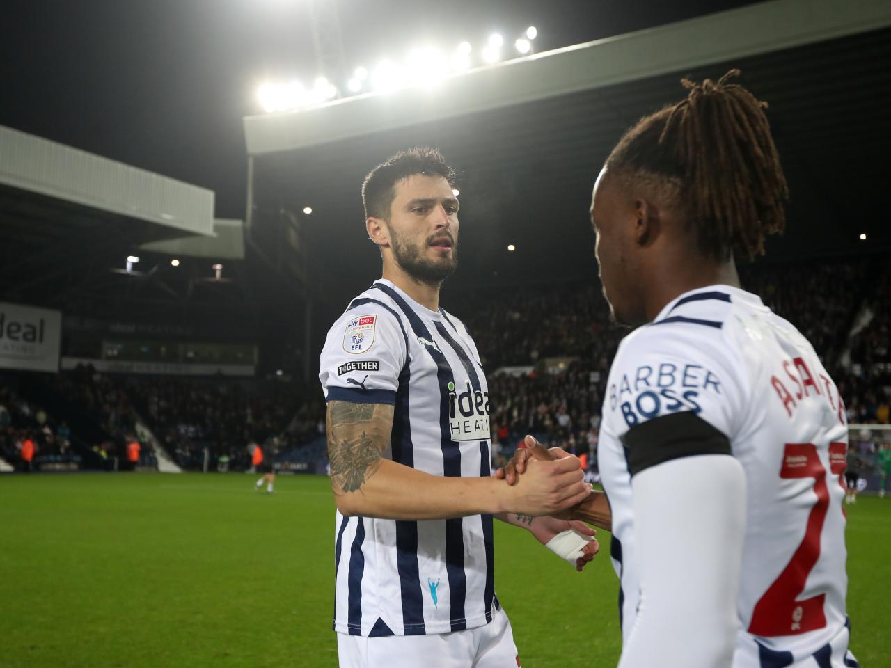 Okay Yokuslu and Brandon Thomas-Asante shake hands moments before kick-off