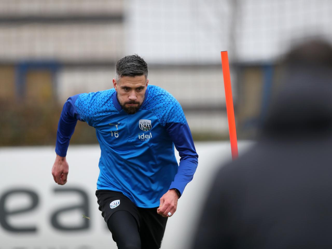 Martin Kelly running forwards in training 