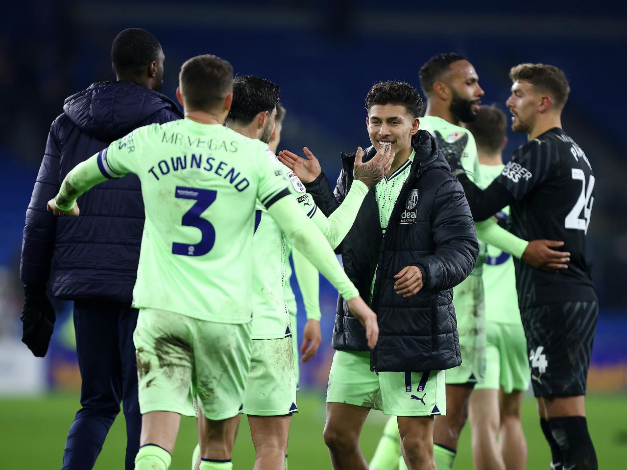 A group of Albion players celebrate the win at full-time