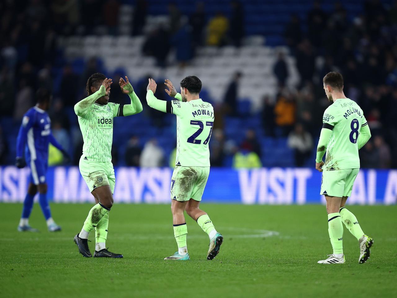 A group of Albion players celebrate the win at full-time