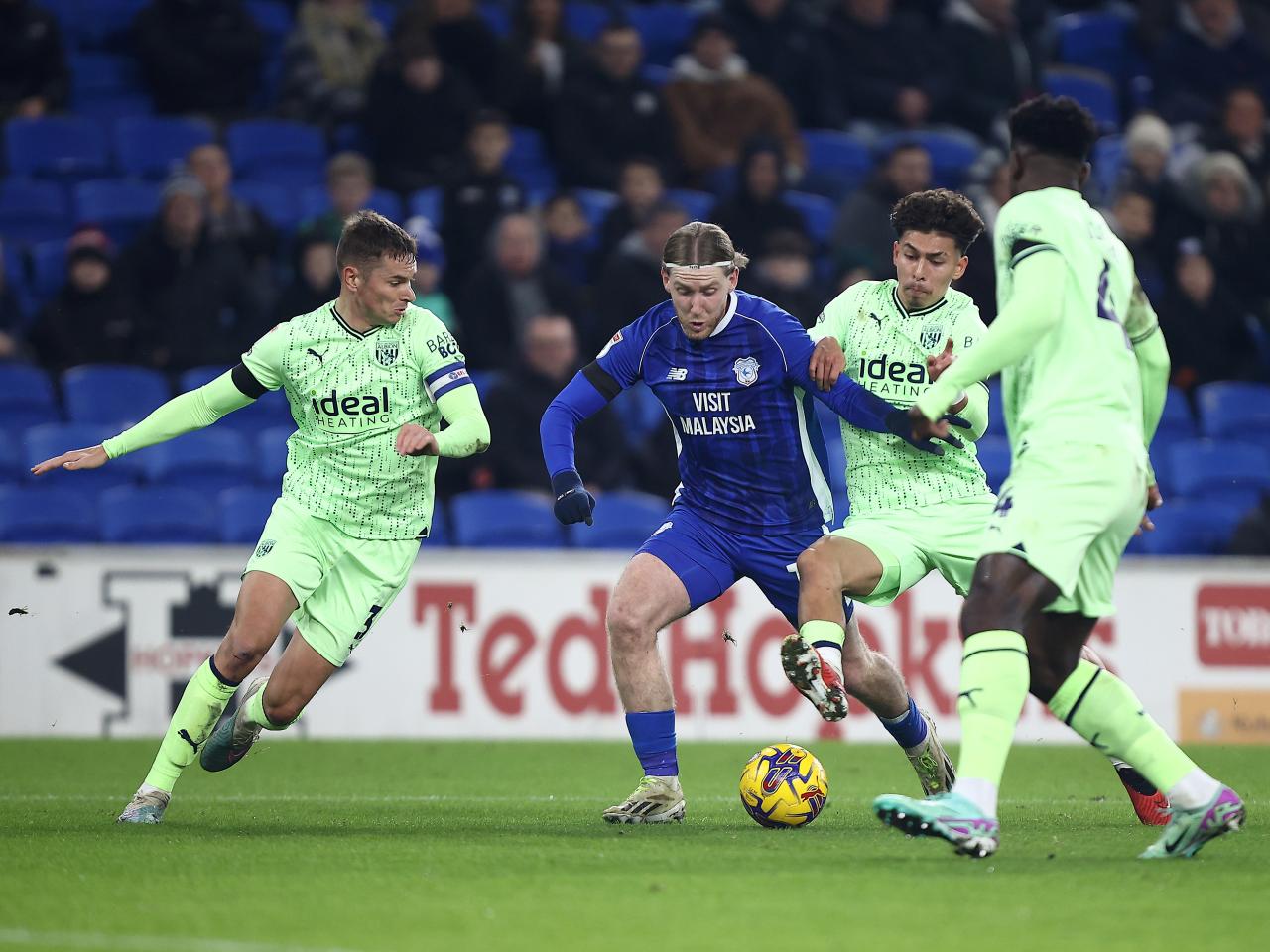 Three Albion players track down a Cardiff attacker