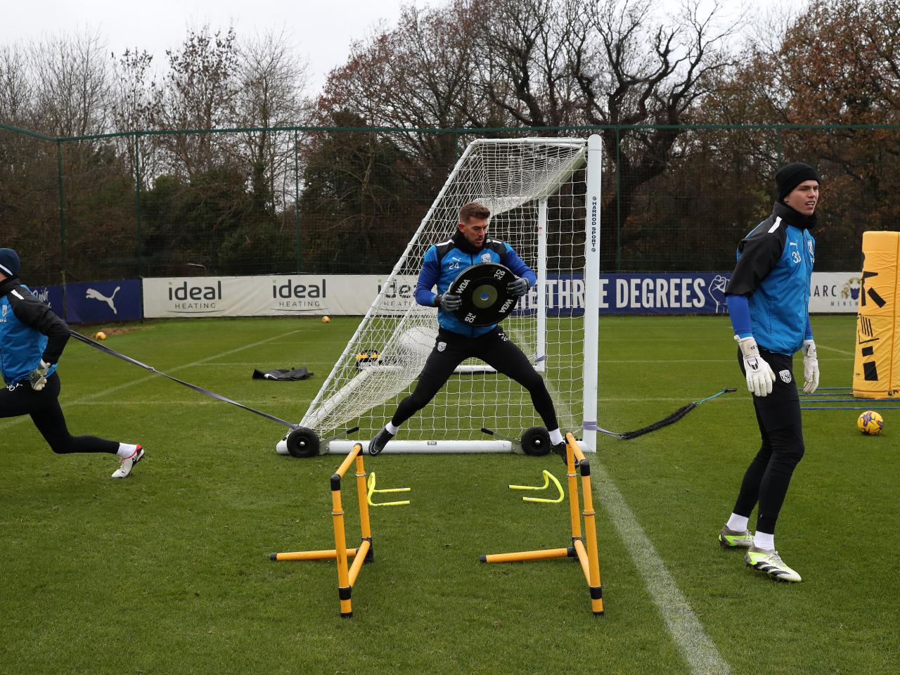 Ted Cann, Alex Palmer and Josh Griffiths warming up ahead of the training session