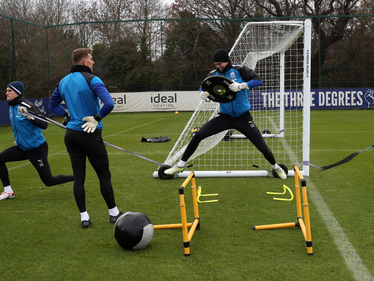 Josh Griffiths jumping in the air while holding a free weight