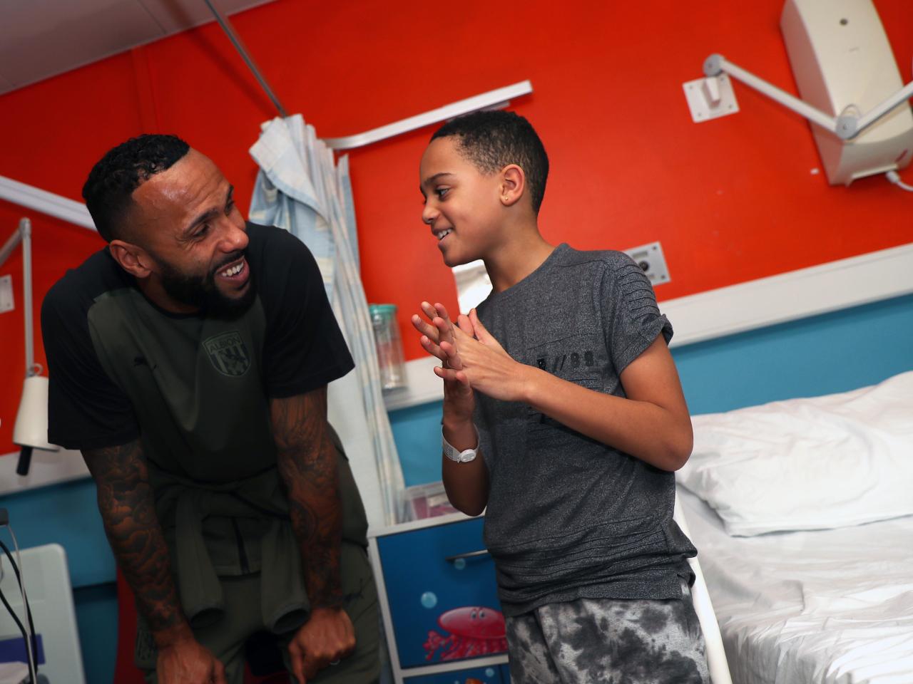 Kyle Bartley meets a young patient at Sandwell General Hospital