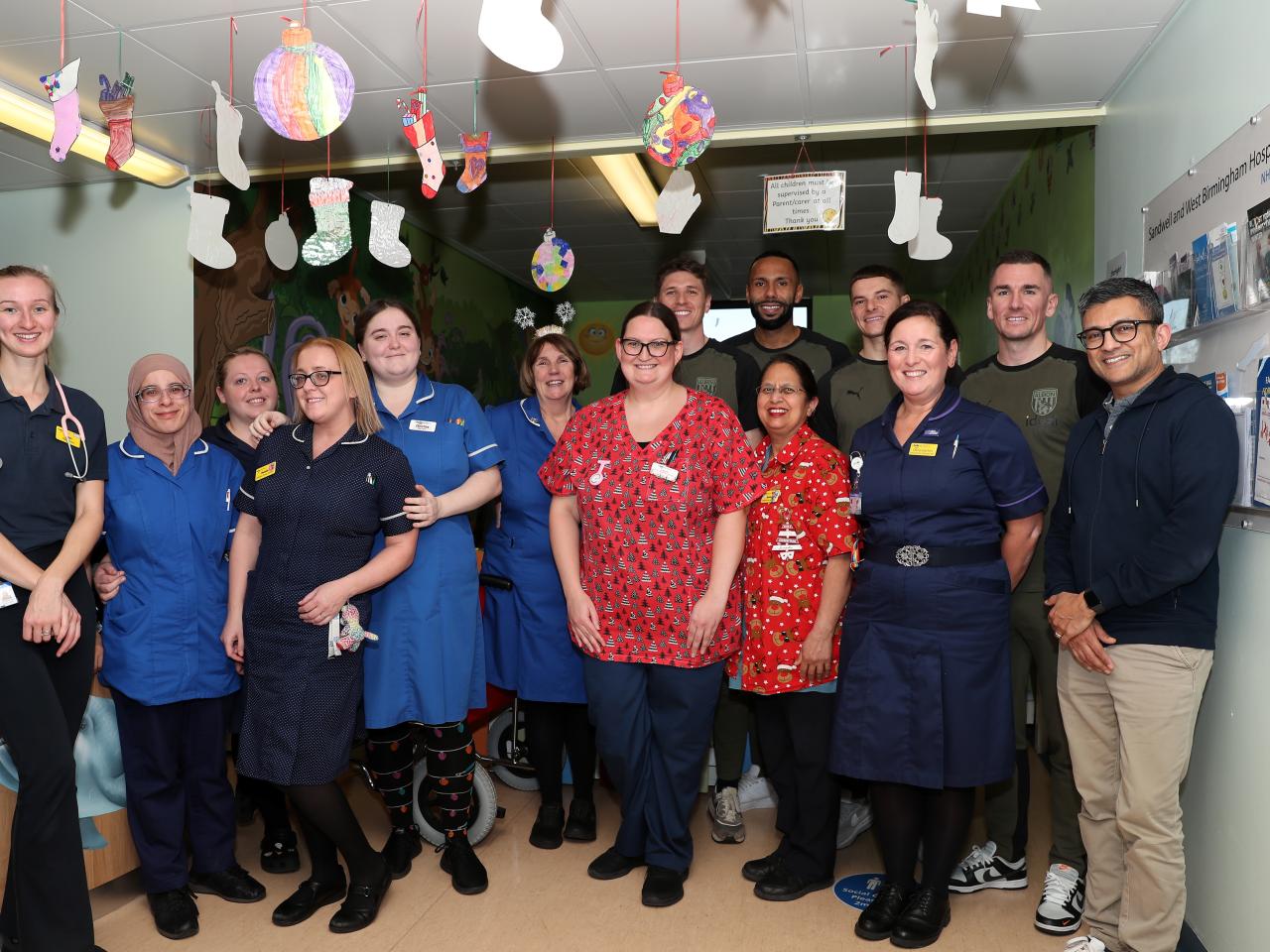 Kyle Bartley, Conor Townsend, Adam Reach and Jed Wallace pose for a photo with NHS workers at Sandwell General Hospital