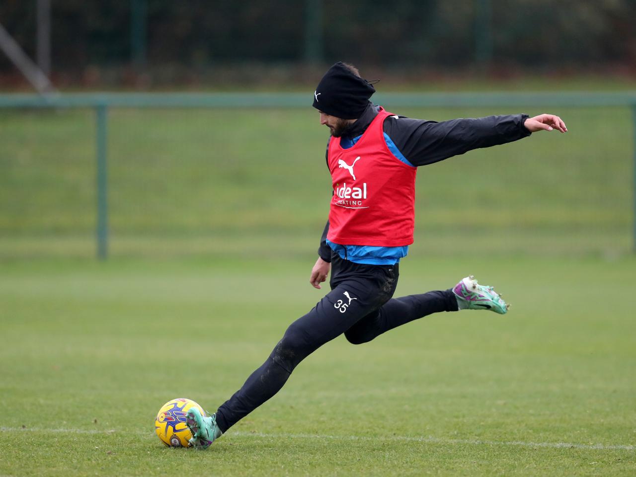 Okay Yokuslu takes a shot in training 