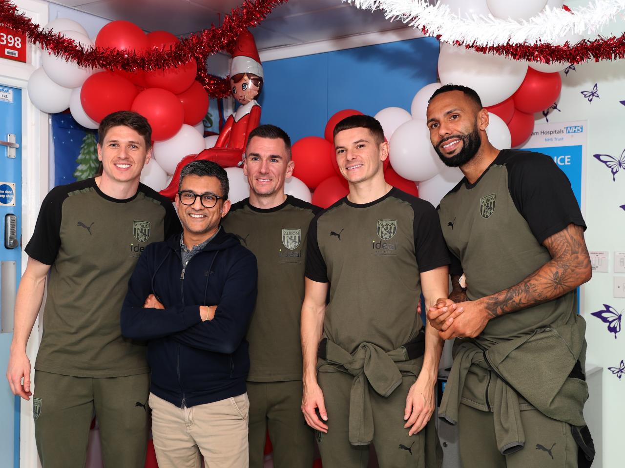 Kyle Bartley, Conor Townsend, Adam Reach and Jed Wallace pose for a photo with NHS workers at Sandwell General Hospital