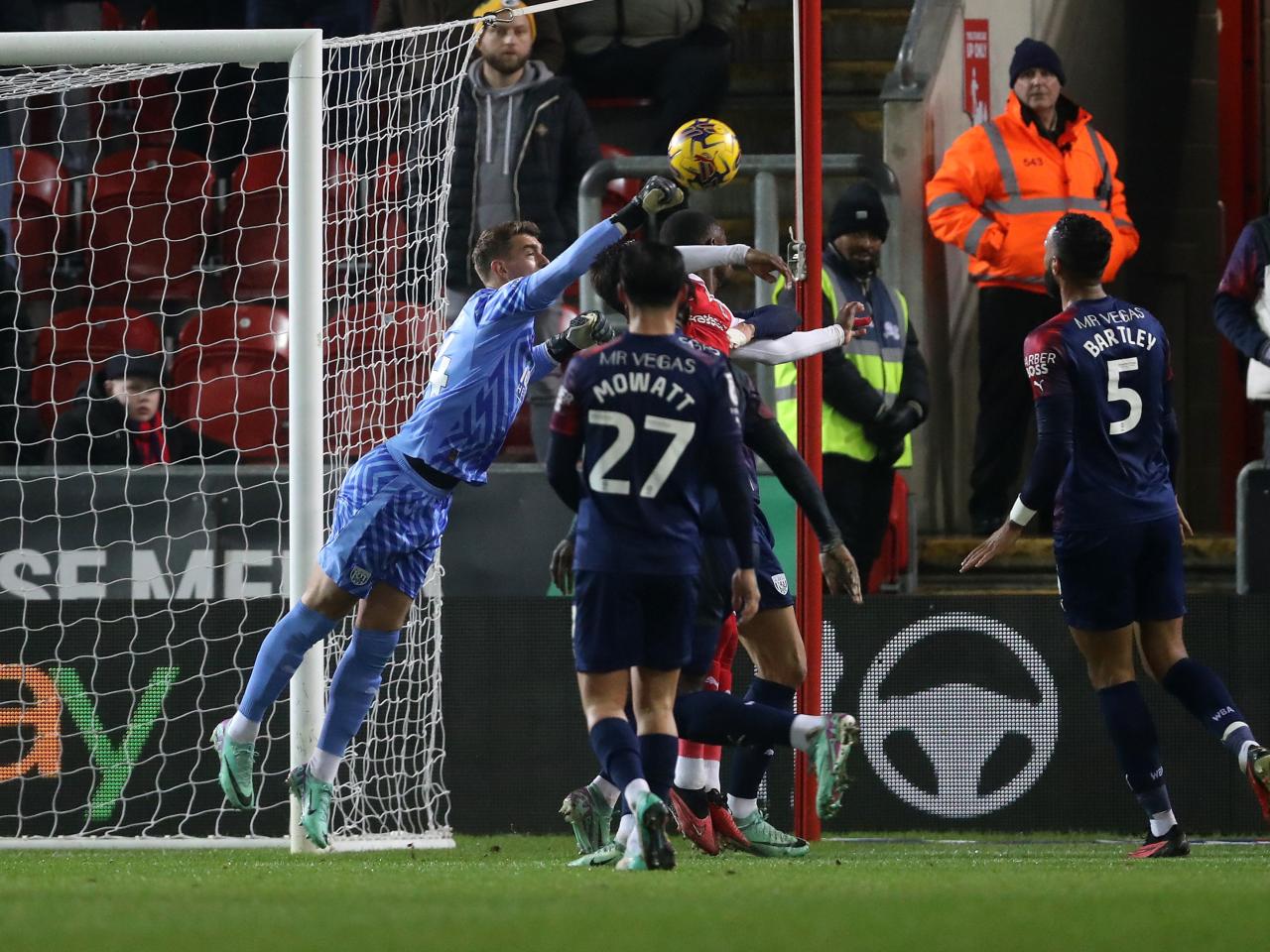 Alex Palmer punching the ball away at Rotherham