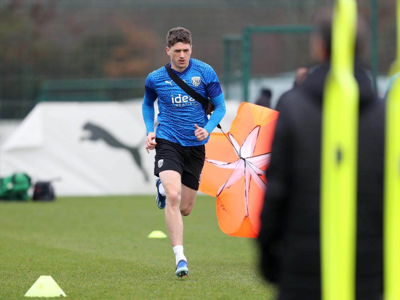 Adam Reach running forward with a weight attached behind him