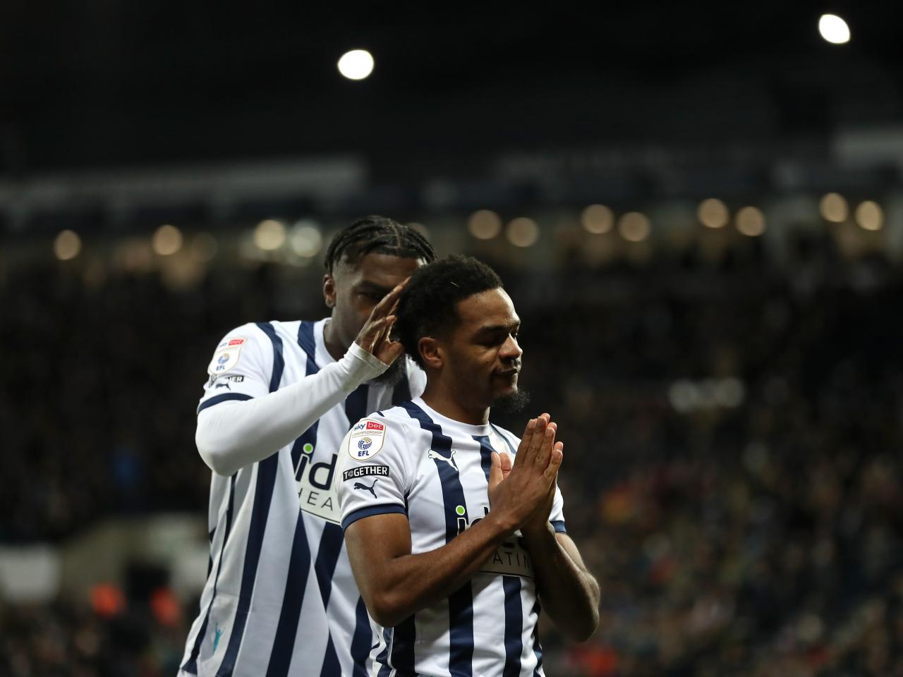 Grady Diangana celebrates scoring against Leeds with Cedric Kipre