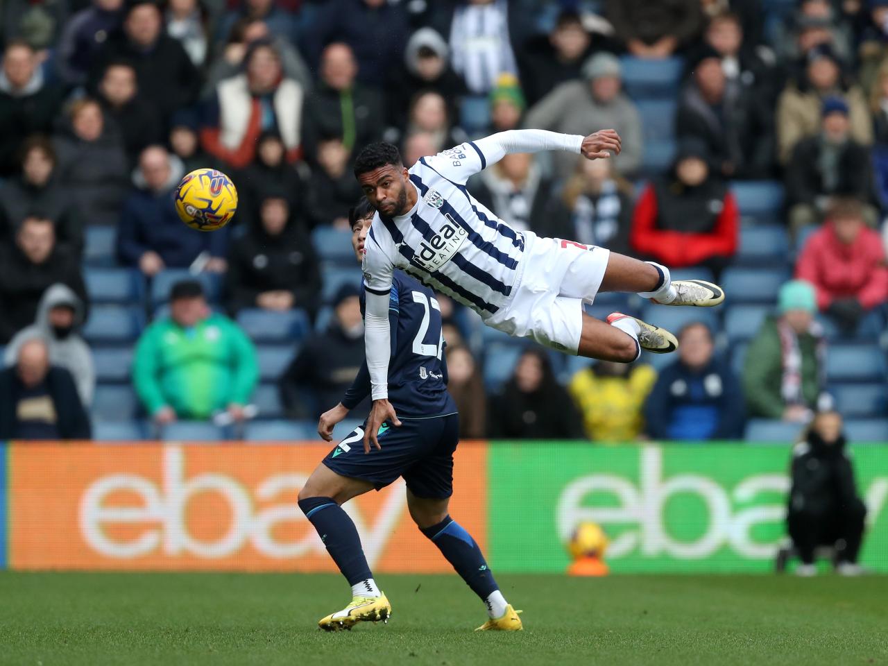 Darnell Furlong flying through the air to head the ball against Stoke