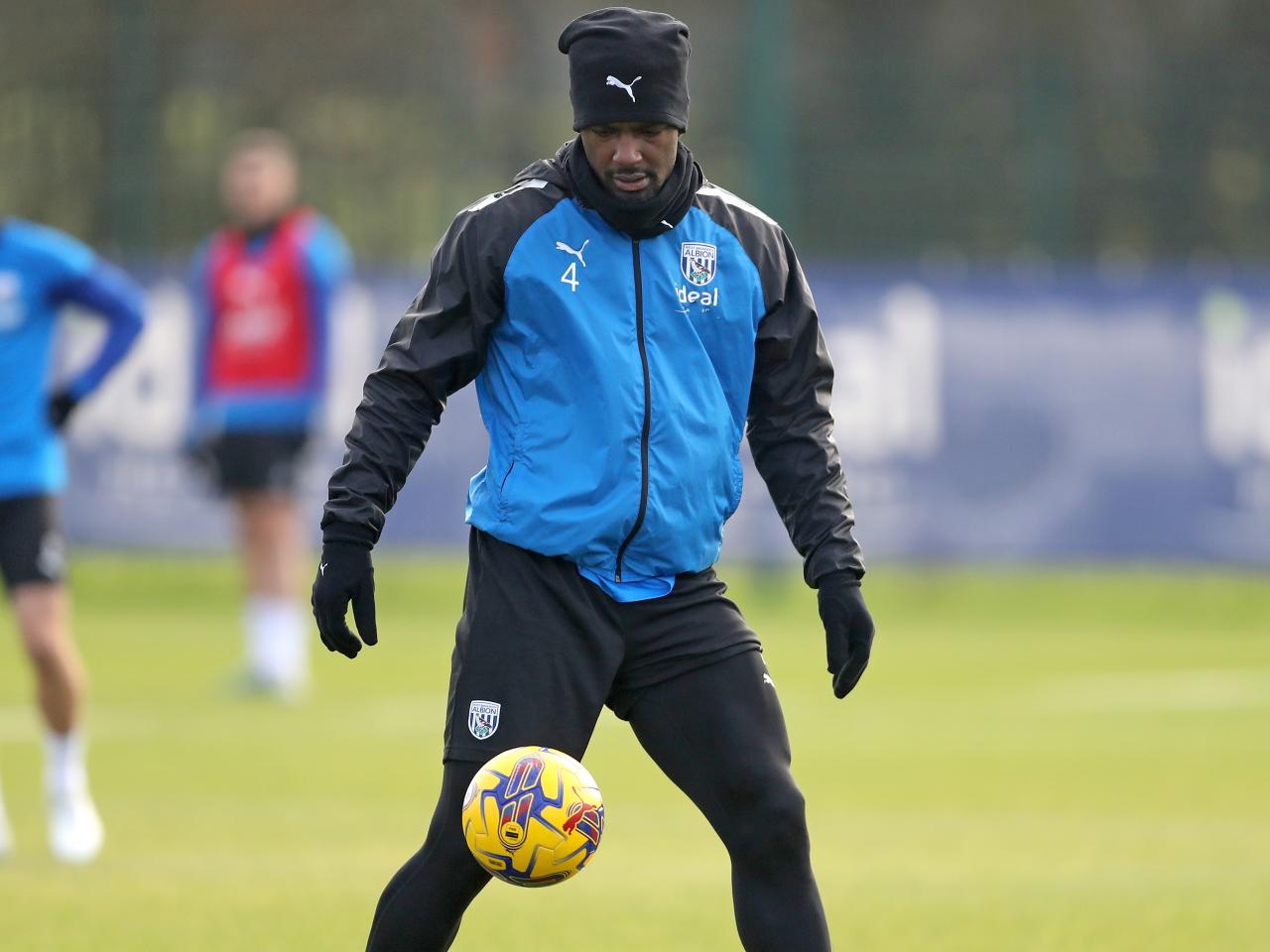 Cedric Kipre on the ball in training while wearing a hat