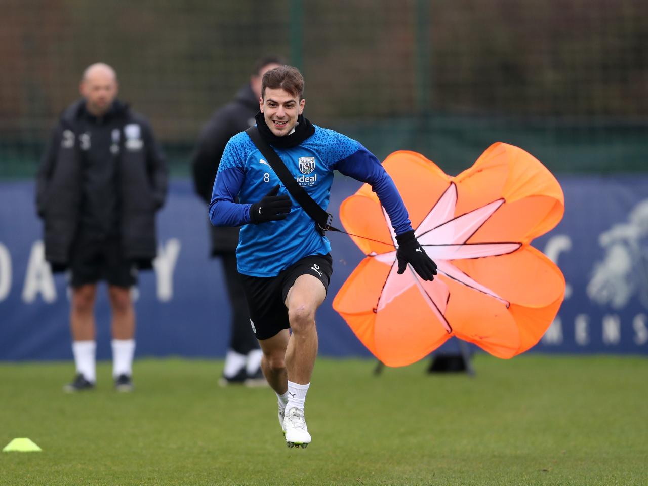 Jayson Molumby running forward with a weight attached behind him