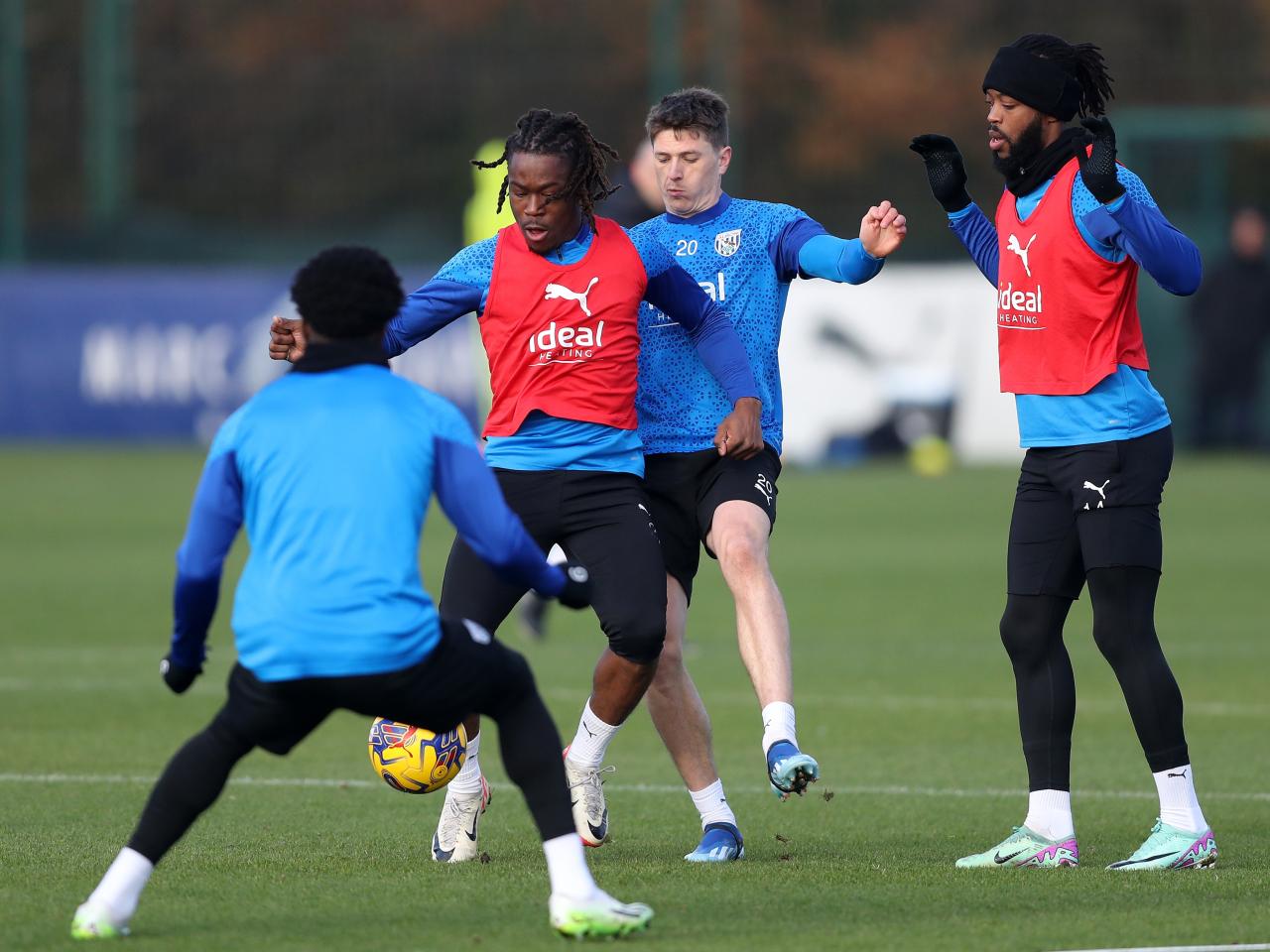 Brandon Thomas-Asante under pressure from other players in training 