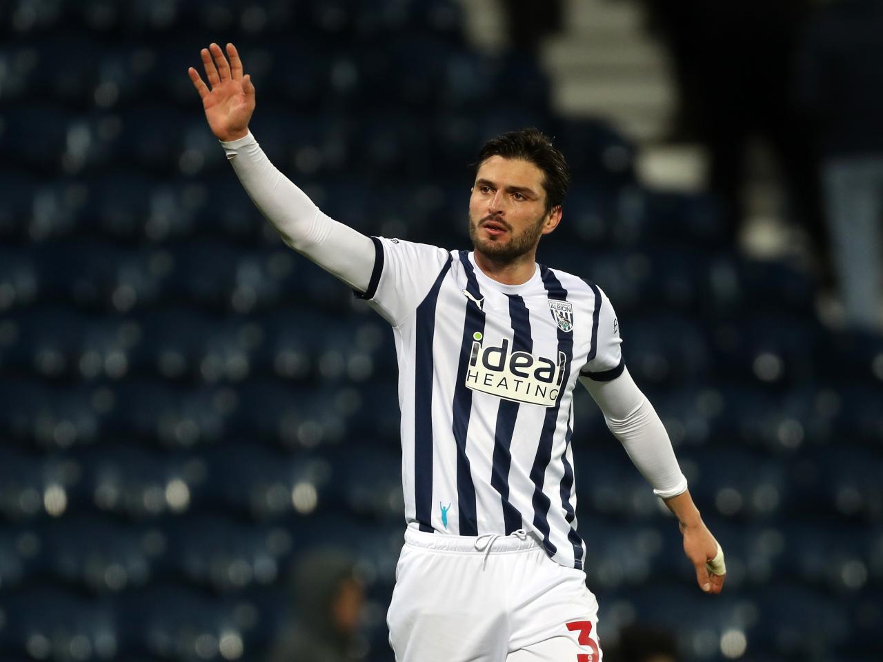 Okay Yokuslu waves at supporters at full-time against Norwich