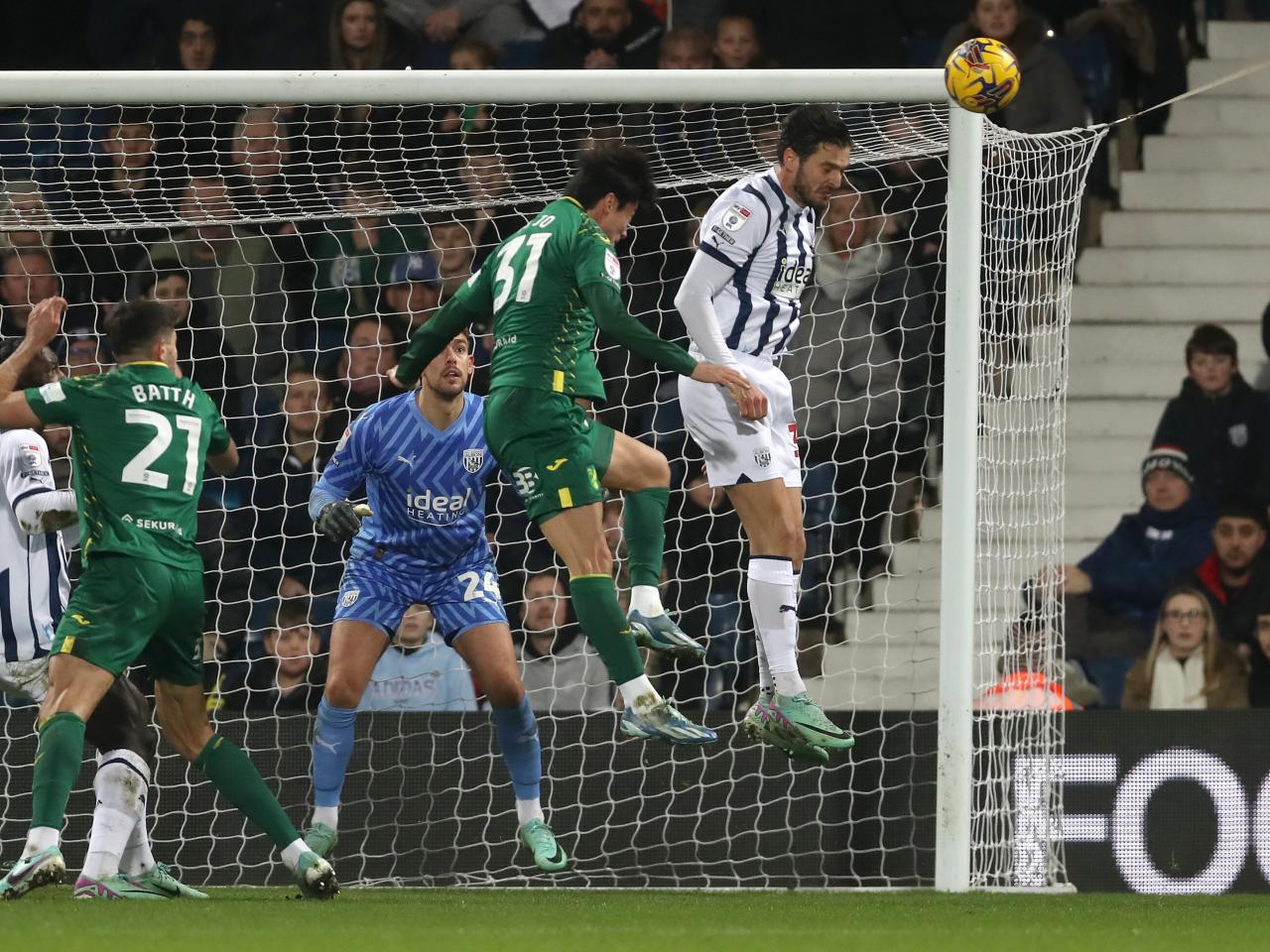 Okay Yokuslu heads the ball away against Norwich