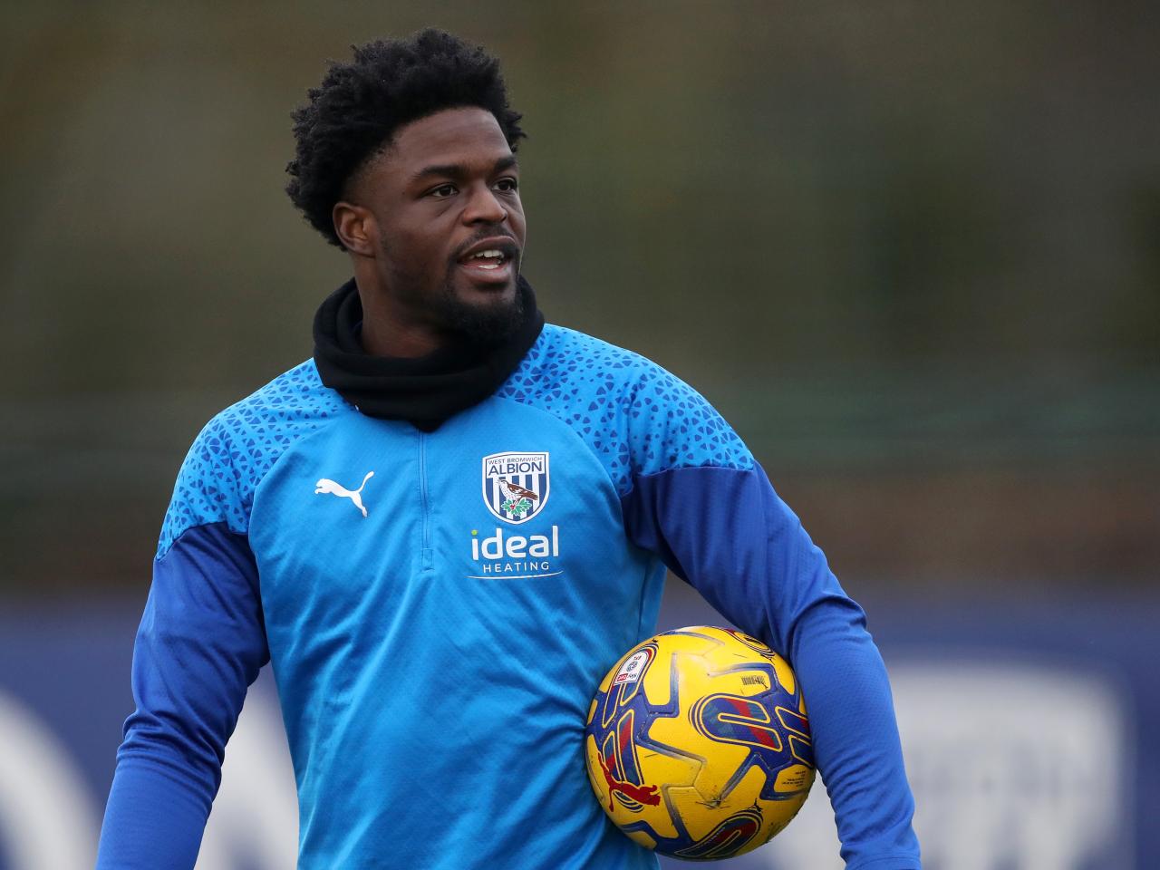 Josh Maja smiling while holding the football