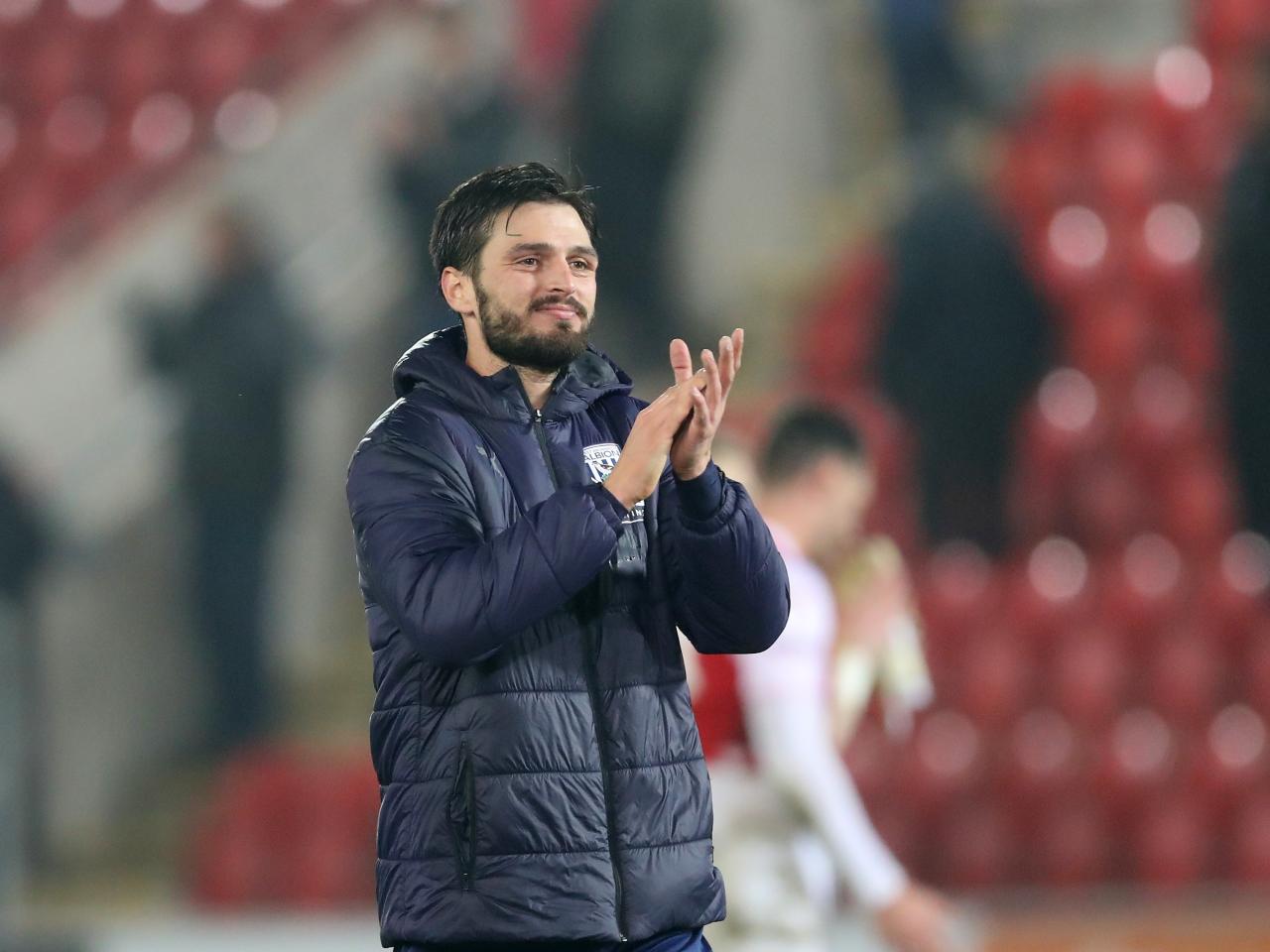 Okay Yokuslu applauds Albion fans after the match
